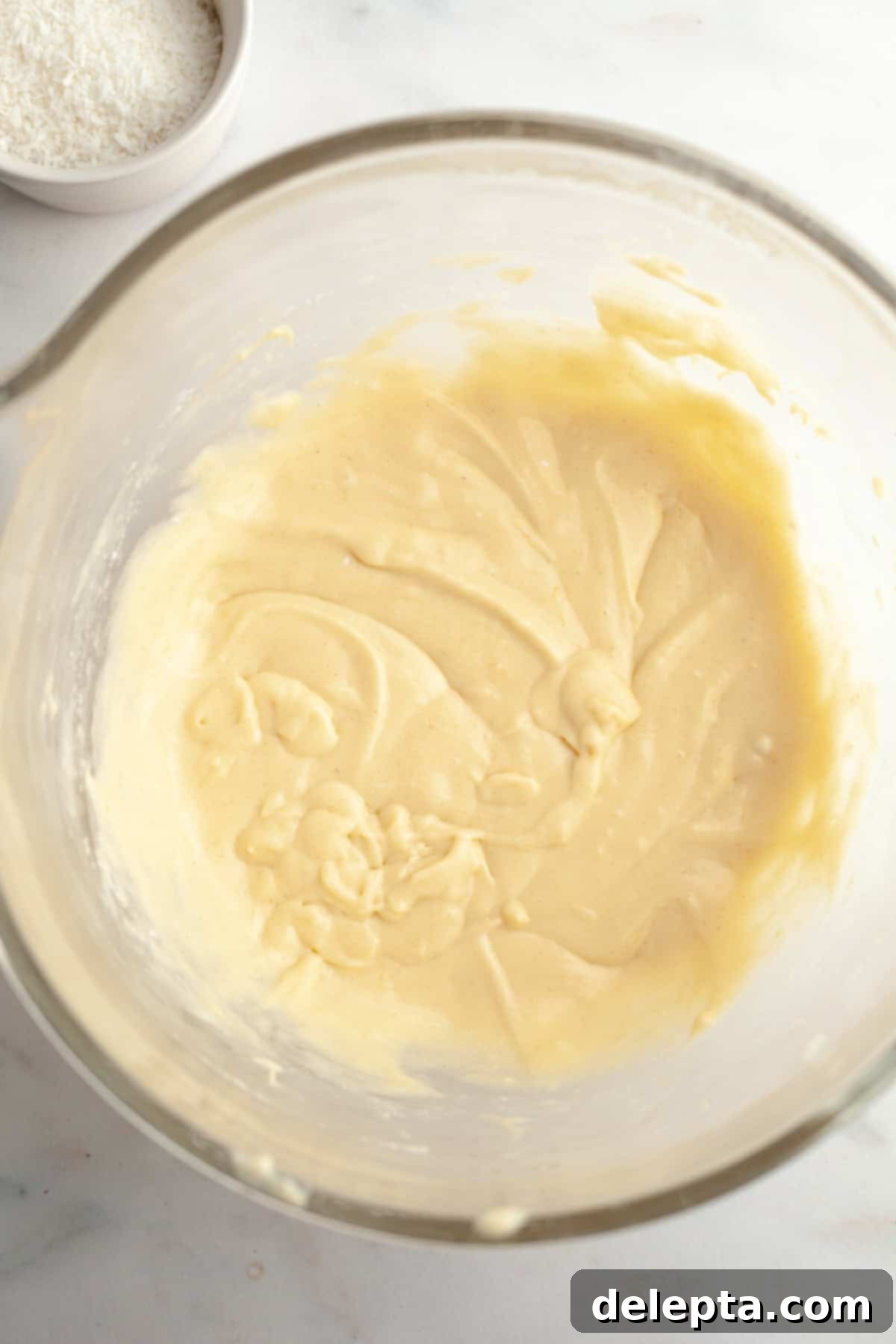 Double Chocolate Coconut Indulgence 6 A yellow cupcake batter in a glass mixing bowl.