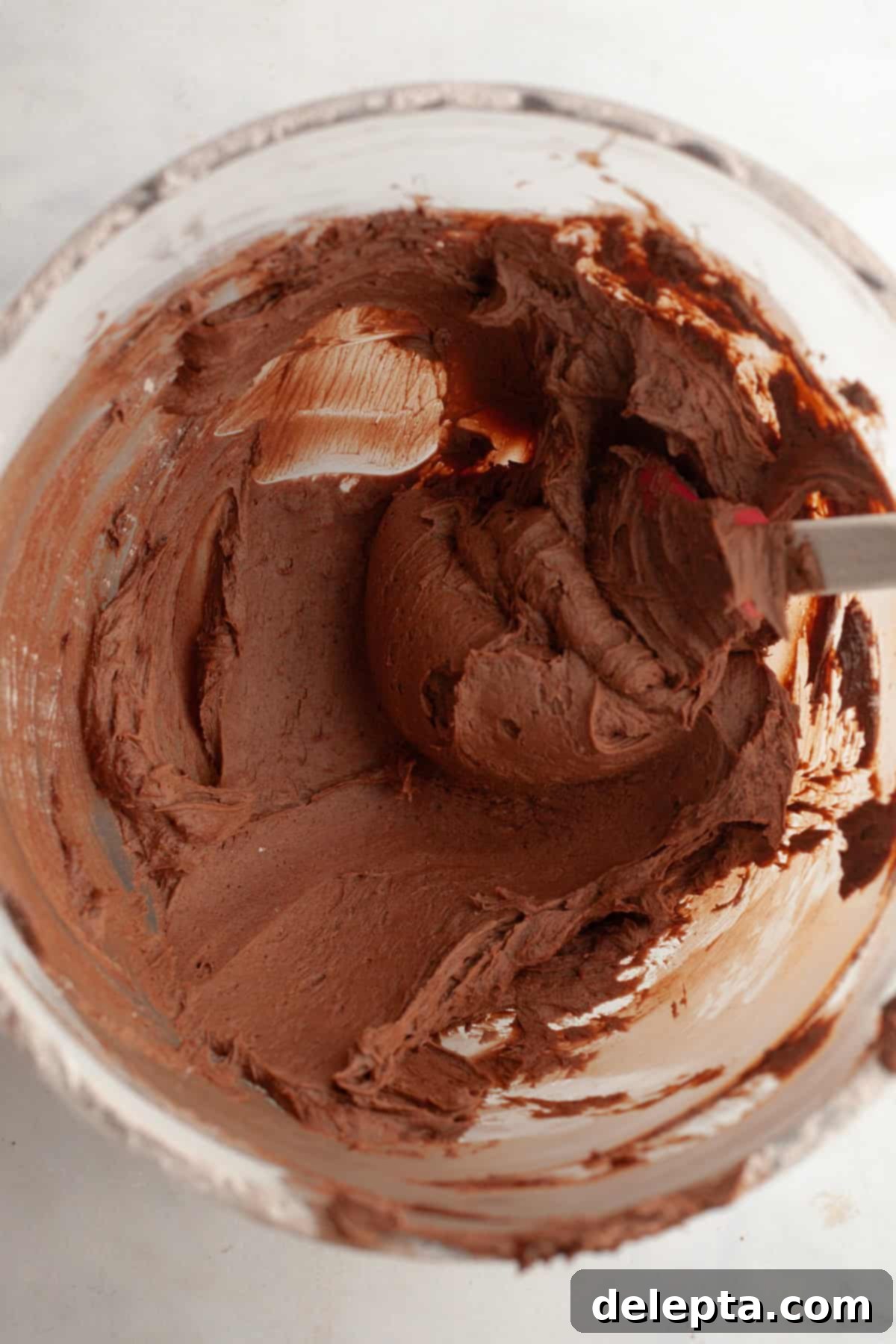 Double Chocolate Coconut Indulgence 9 Chocolate frosting in a glass mixing bowl.