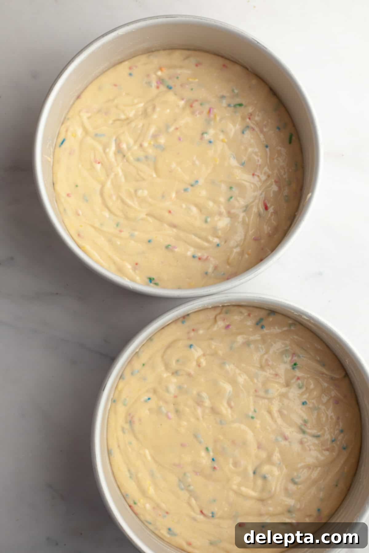 Simply Delicious Funfetti Oreo Cake with Dreamy Oreo Frosting 7 Unbaked funfetti cake batter, loaded with colorful sprinkles, evenly divided between two 8-inch cake pans.