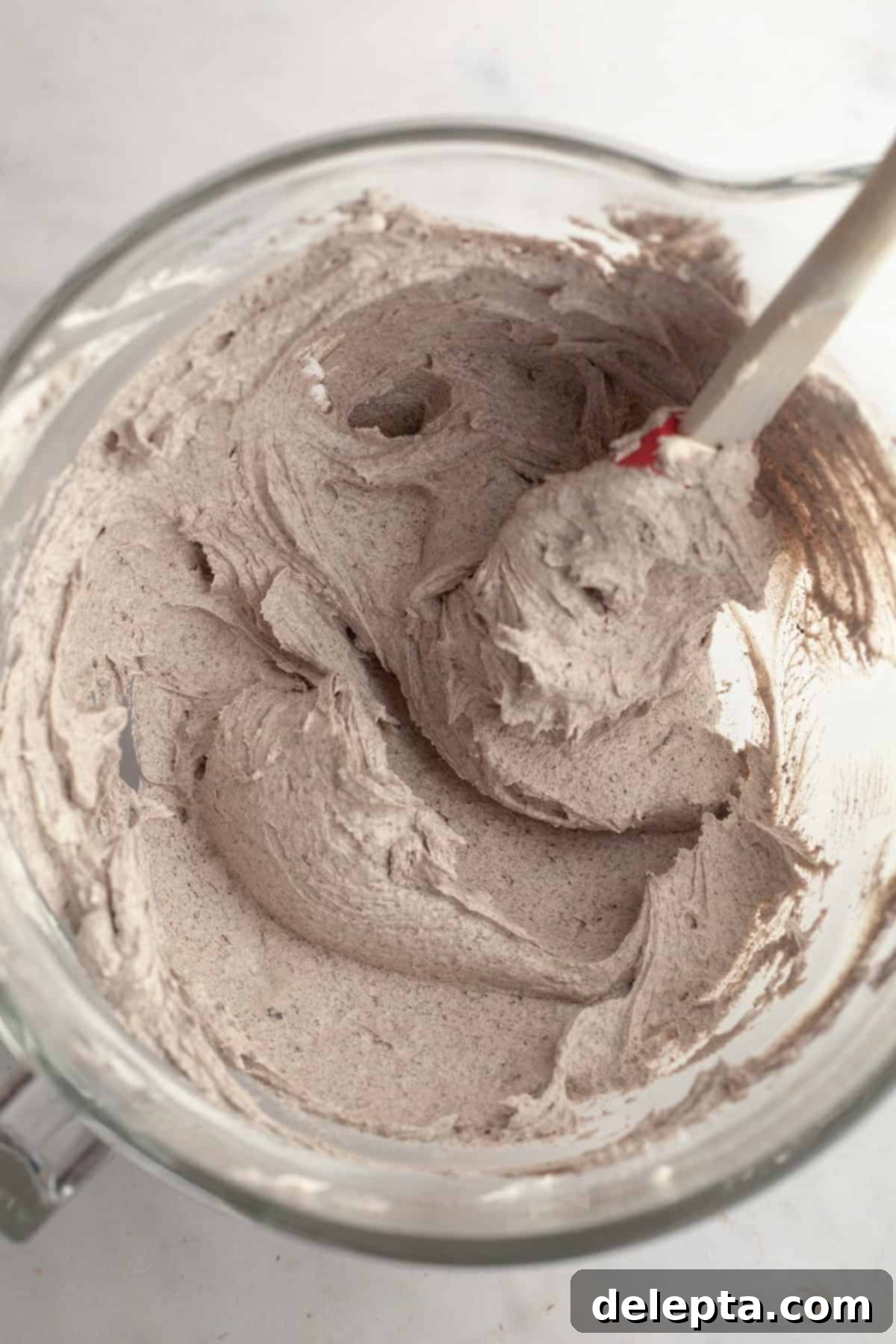 Simply Delicious Funfetti Oreo Cake with Dreamy Oreo Frosting 9 Rich, dark Oreo frosting with visible cookie crumbs in a large mixing bowl.