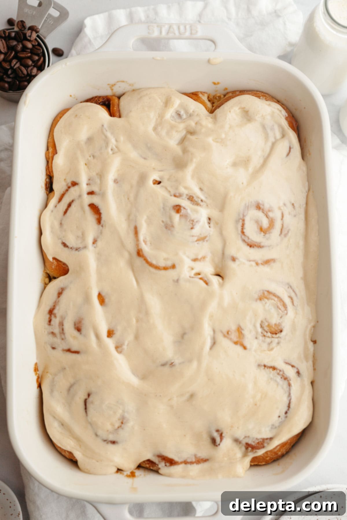 Maple Espresso Cinnamon Swirls 11 Cinnamon coffee rolls covered in maple espresso icing in a rectangular dish.