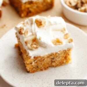 Butter-Free Mini Carrot Cake with Dreamy Cream Cheese Frosting 10 A slice of mini carrot cake with cream cheese frosting and chopped walnuts.