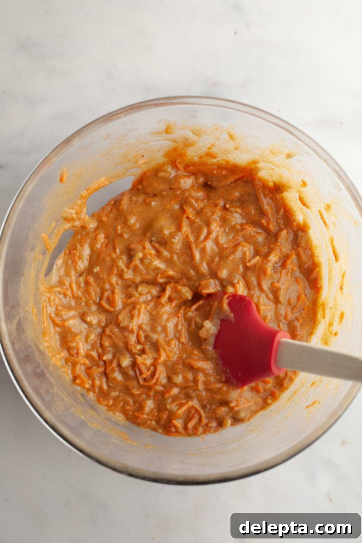 Butter-Free Mini Carrot Cake with Dreamy Cream Cheese Frosting 5 Carrot cake batter in a bowl.