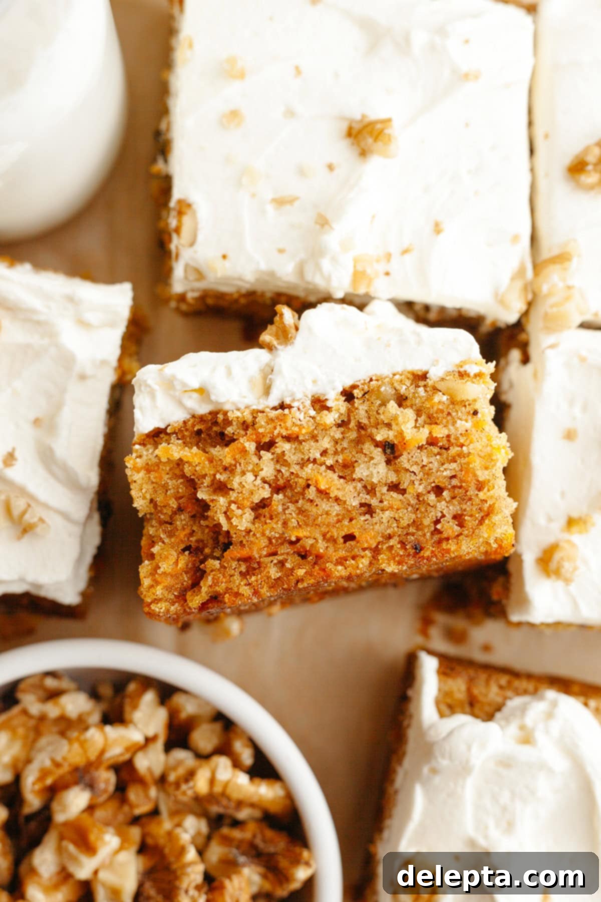 Butter-Free Mini Carrot Cake with Dreamy Cream Cheese Frosting 8 A close up of a square slice of a mini carrot snack cake with cream cheese frosting.