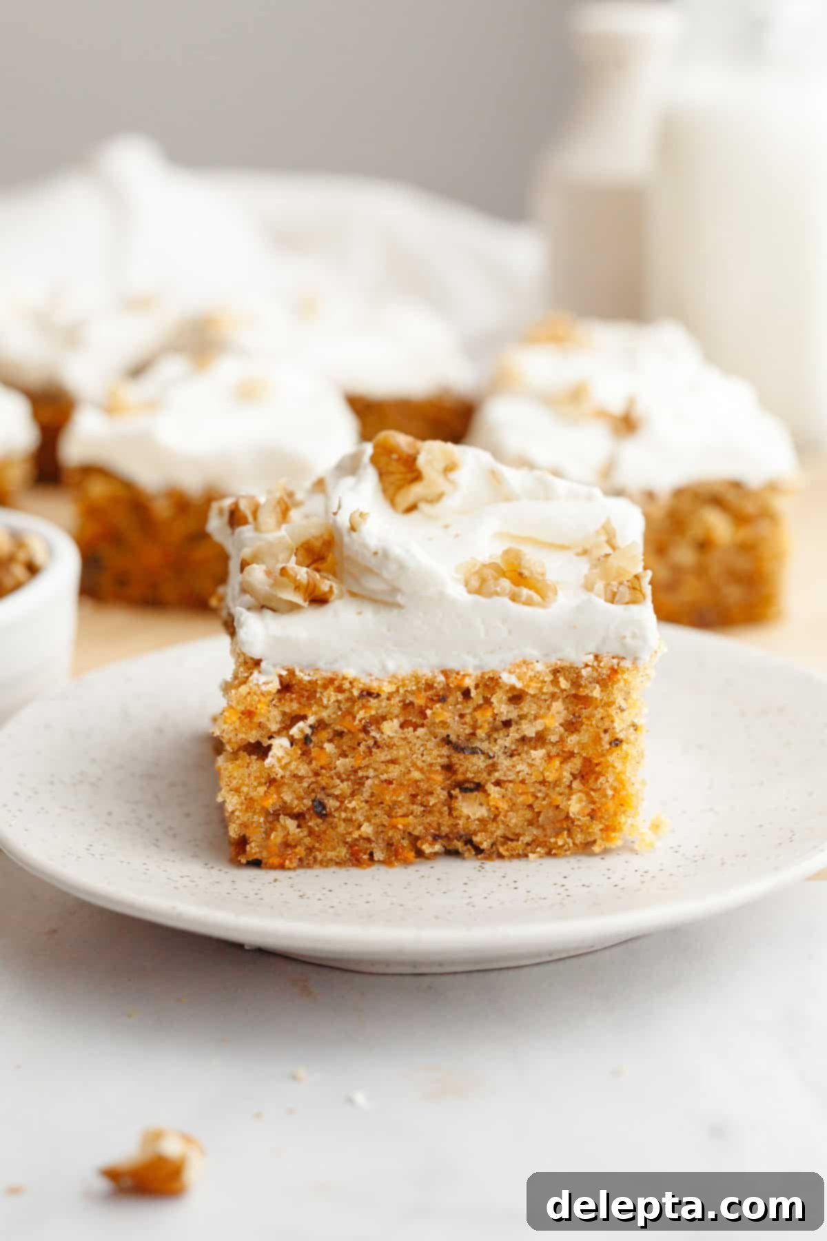Butter-Free Mini Carrot Cake with Dreamy Cream Cheese Frosting 9 A slice of mini carrot cake with cream cheese frosting on a small plate.