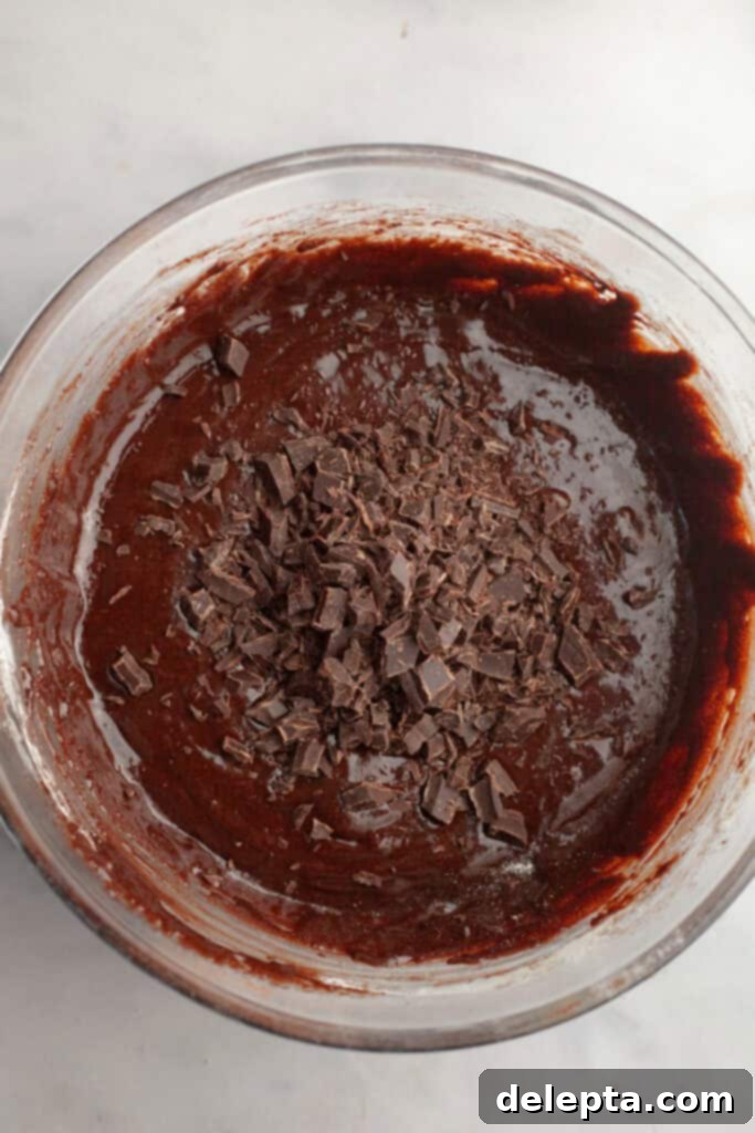 Decadent One Bowl Fudgy Brown Butter Espresso Brownies 7 Thick brownie batter with finely chopped chocolate shards stirred in, ready for baking.
