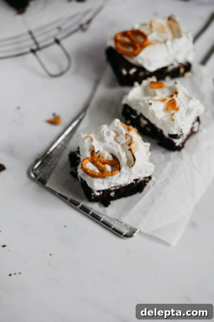Fireside S'mores Brownies 4 Three individual campfire brownies, each topped with golden toasted marshmallow meringue and pretzel bits