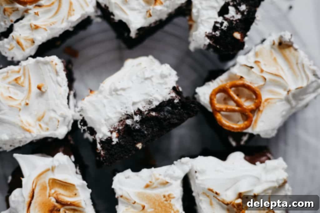 Fireside S'mores Brownies 6 A tray of cut up campfire brownies, showing their rich texture and toasted meringue topping
