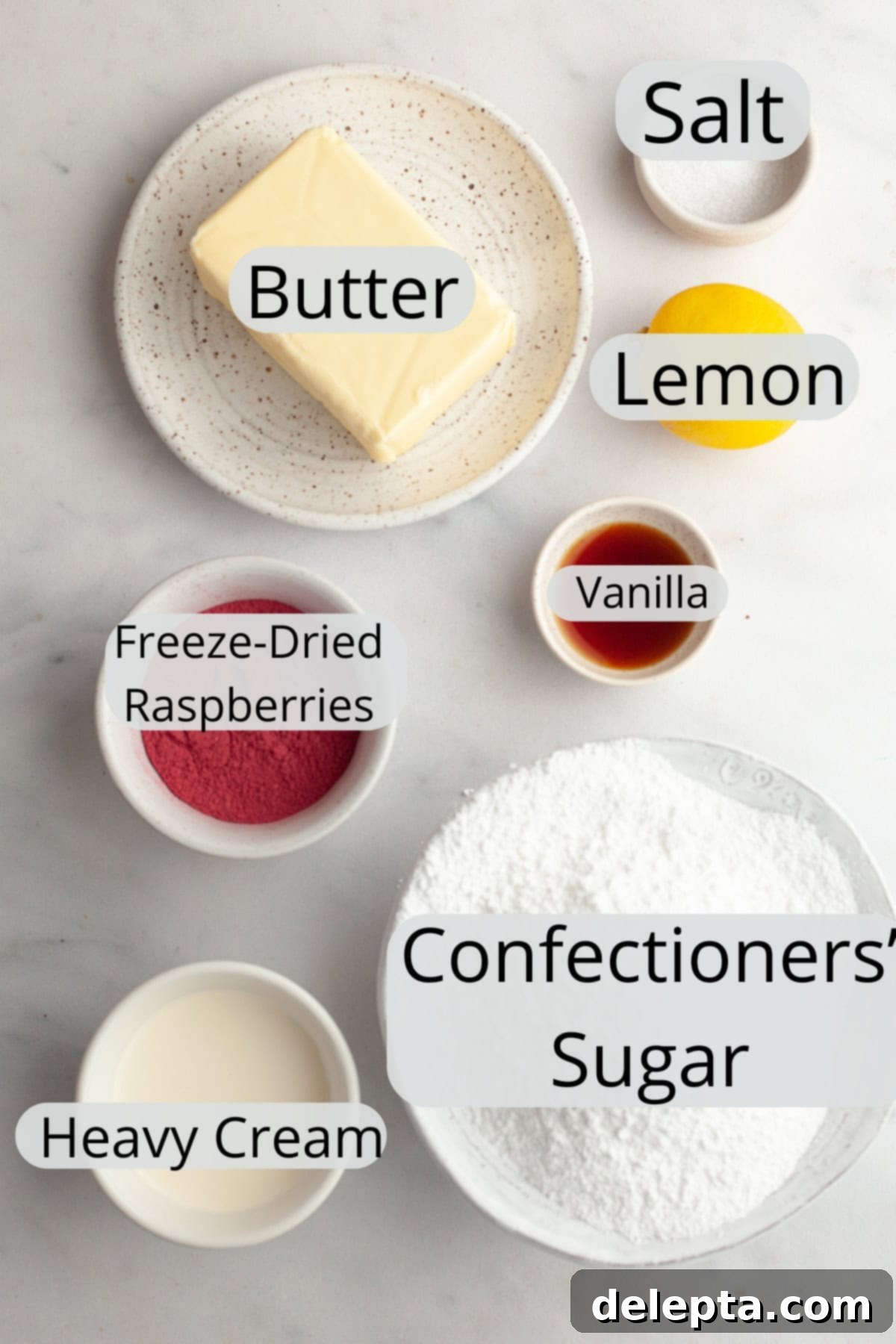 Raspberry Dream Buttercream 3 All the ingredients needed to make raspberry buttercream, carefully weighed out into small bowls on a wooden surface.