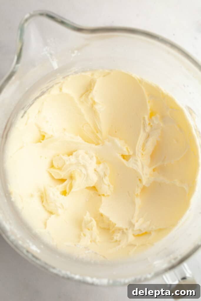 Raspberry Dream Buttercream 4 Butter and icing sugar mixed in a large glass mixing bowl, light and fluffy.