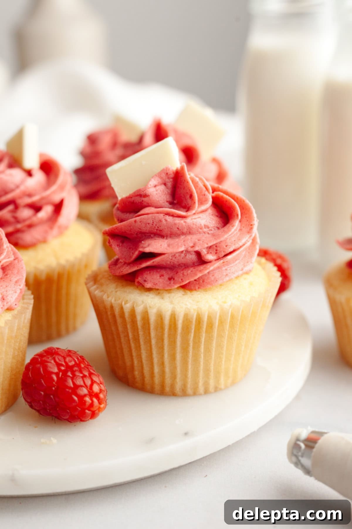 Decadent Raspberry White Chocolate Ganache Cupcakes 12 Vanilla cupcakes frosted with pink raspberry buttercream.