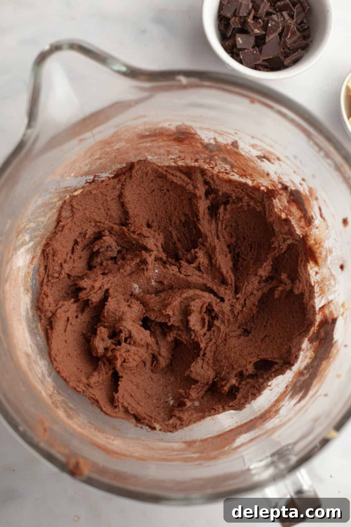 Chewy Triple Chocolate Chunk One Bowl Cookies 5 Chocolate cookie dough in a glass bowl after dry ingredients are added.