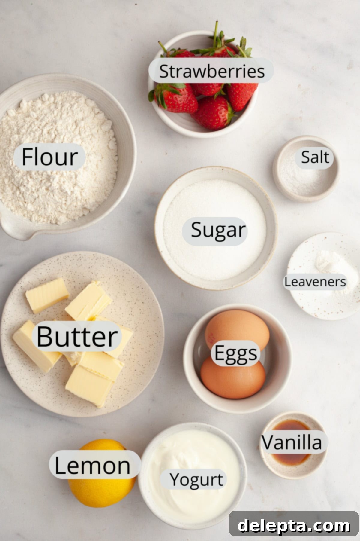 Simple One-Bowl Strawberry Snack Cake 3 All the ingredients needed to make a mini strawberry snack cake, weighed out into small bowls.