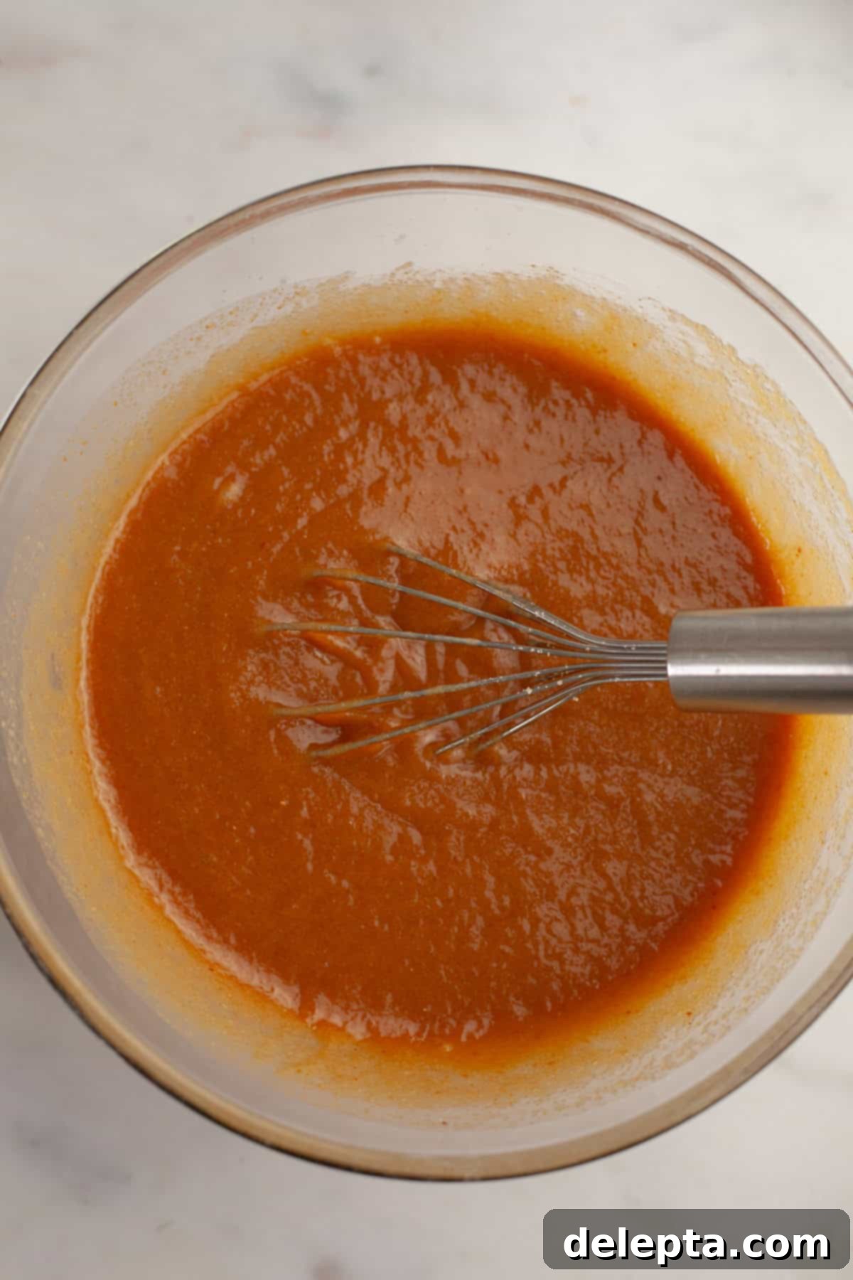 One Bowl Brown Butter Peanut Butter Oreo Perfection 6 Light brown liquid in a glass bowl with a whisk.