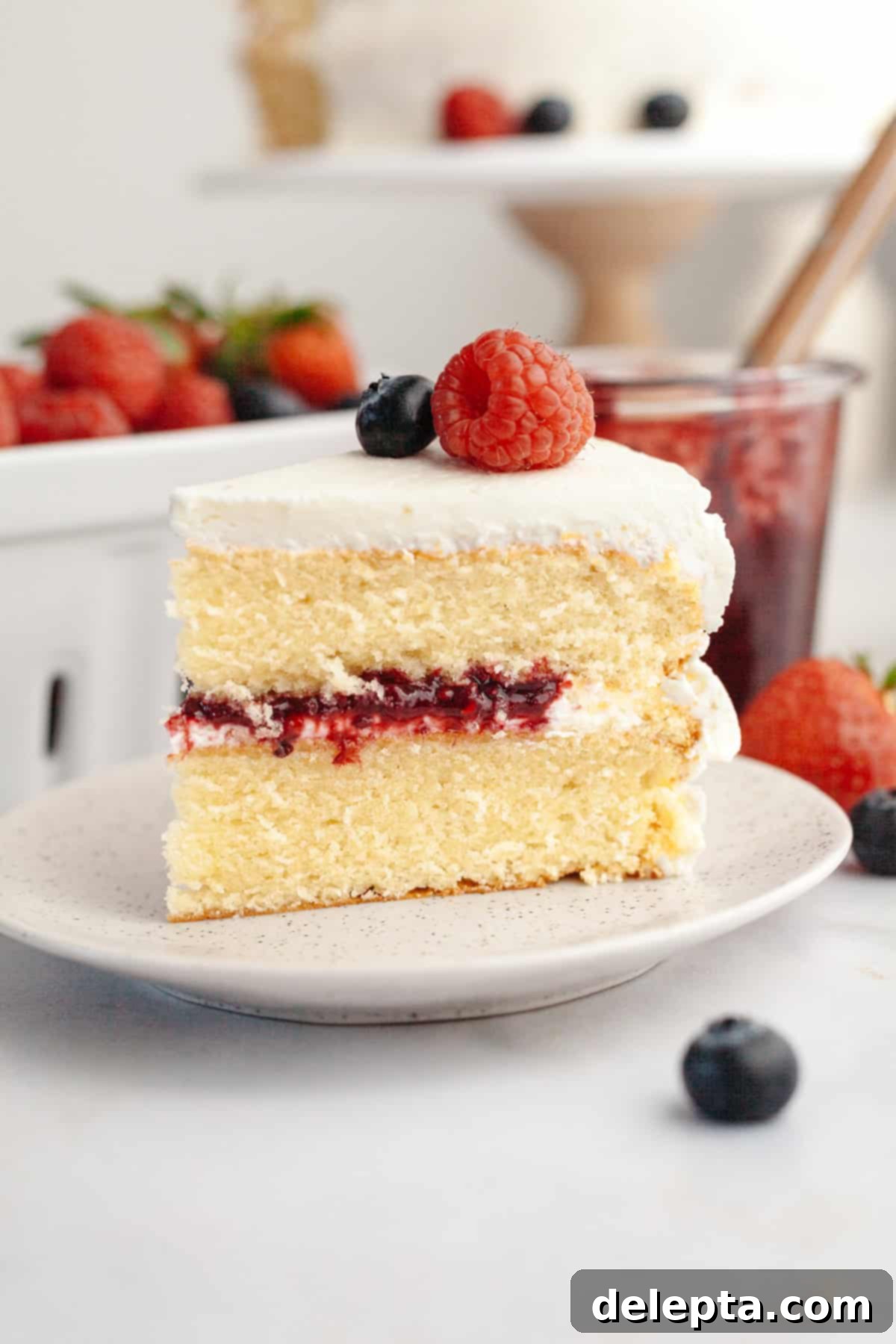 Berry Vanilla Mascarpone Bliss 2 A beautifully decorated berry vanilla cake with white frosting and fresh berries on top, ready for a celebration.