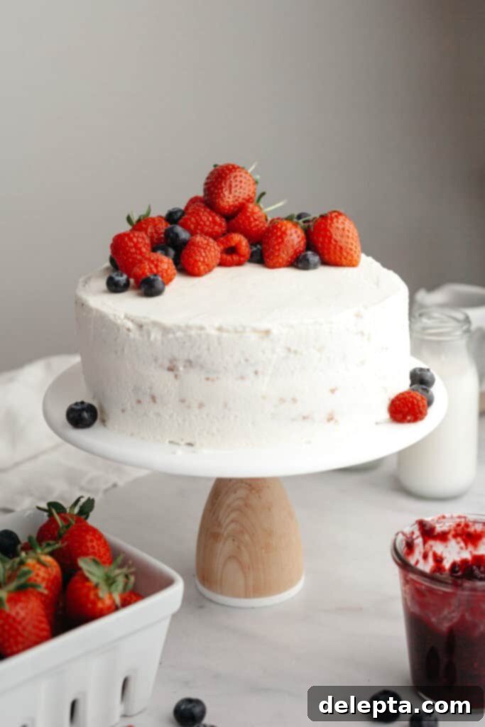 Berry Vanilla Mascarpone Bliss 11 A beautifully decorated berry vanilla cake with white frosting and fresh berries on top, showcasing the elegant final assembly.