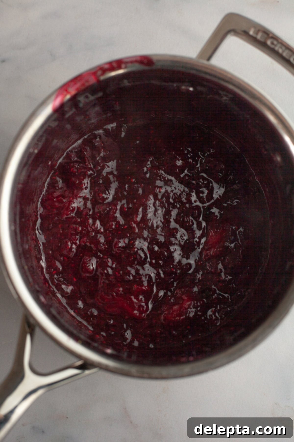 Quick Berry Compote with Frozen Fruit 5 Mixed berry compote in a silver saucepan.