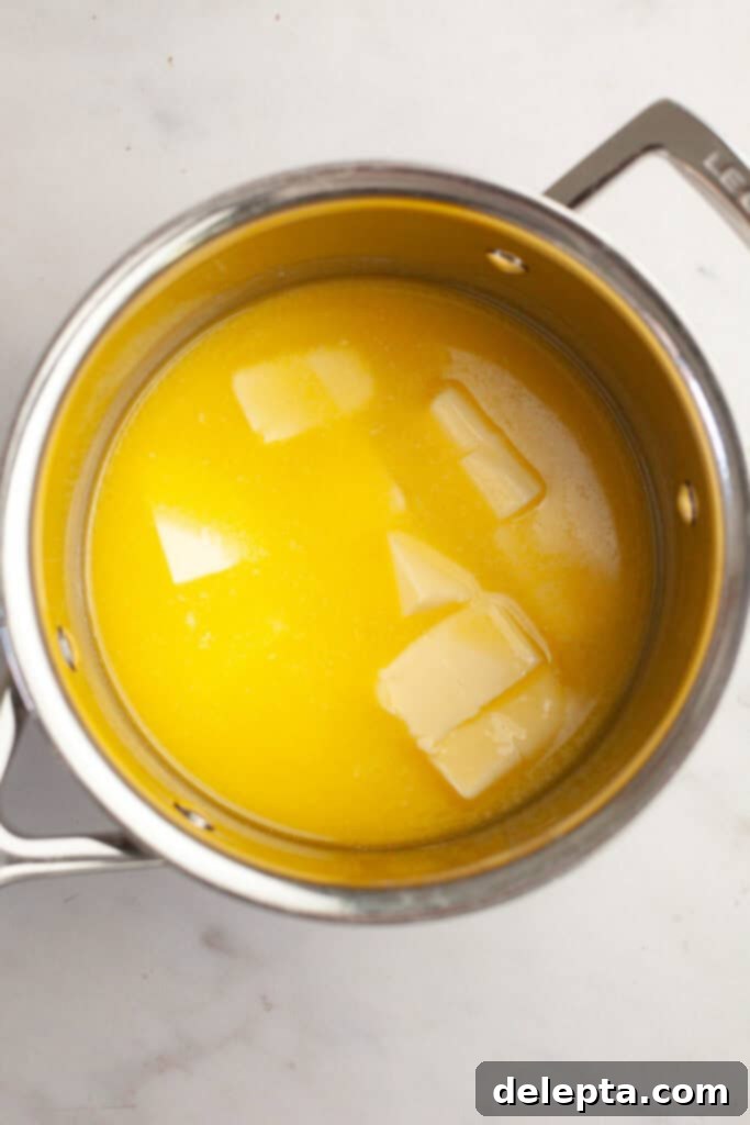 Brown Butter Made Simple 3 A small saucepan on a stove with a stick of unsalted butter melting, showing the initial stage of transformation.