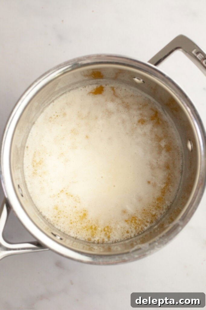 Brown Butter Made Simple 4 Foaming butter in a saucepan, indicating the water is evaporating and the milk solids are beginning to separate and cook.