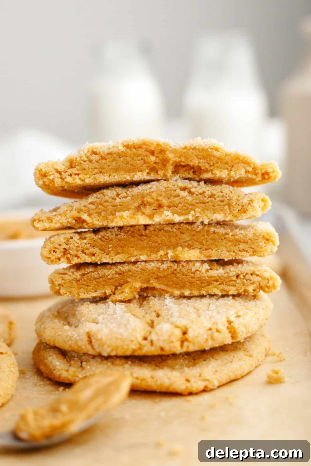 Golden Brown Butter Peanut Butter Cookies Ready Now 2 A stack of perfectly baked brown butter peanut butter cookies, cut in half to show their soft, chewy interior.