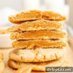 Golden Brown Butter Peanut Butter Cookies Ready Now 11 A stack of perfectly baked browned butter peanut butter cookies, delightfully cut in half.