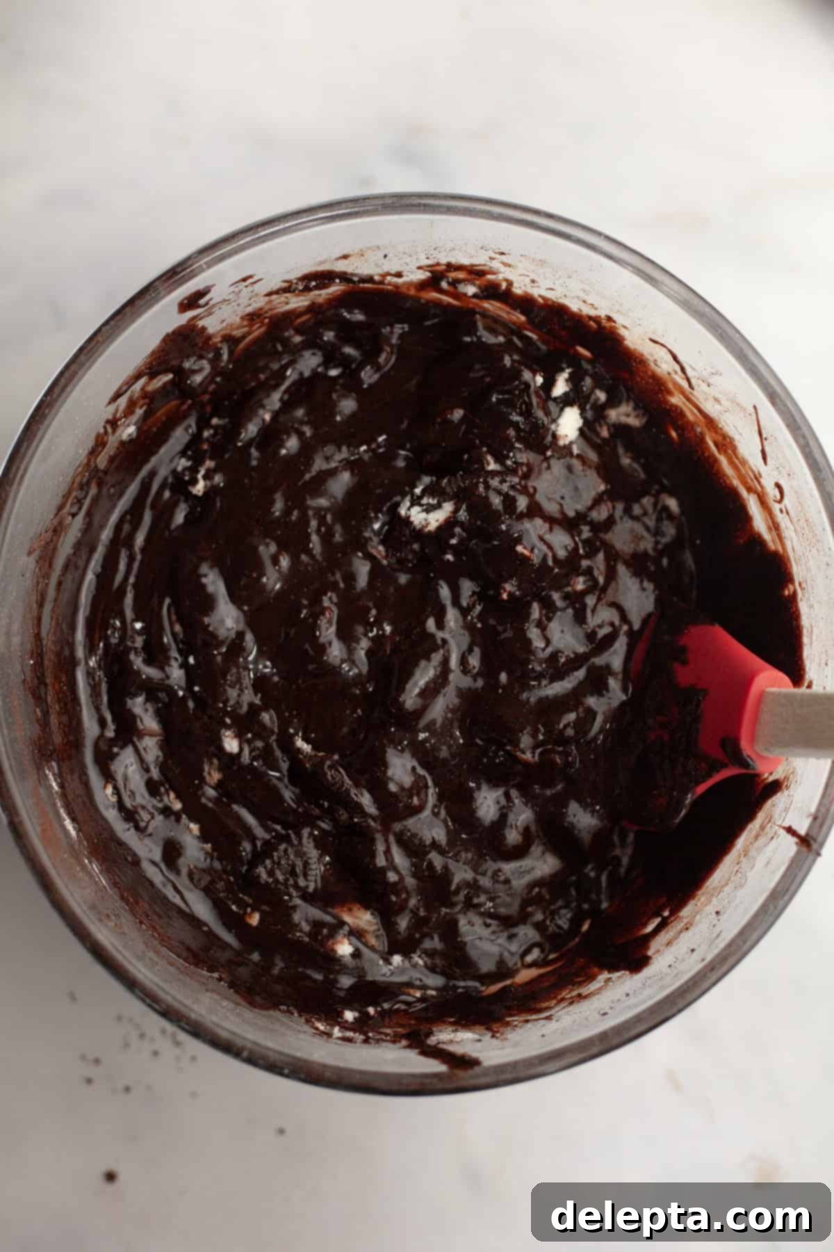 One-Bowl Decadence: Oreo Fudge Brownies 7 A large bowl of brownie batter with visible chunks of chopped chocolate and crushed Oreos, ready to be folded in.