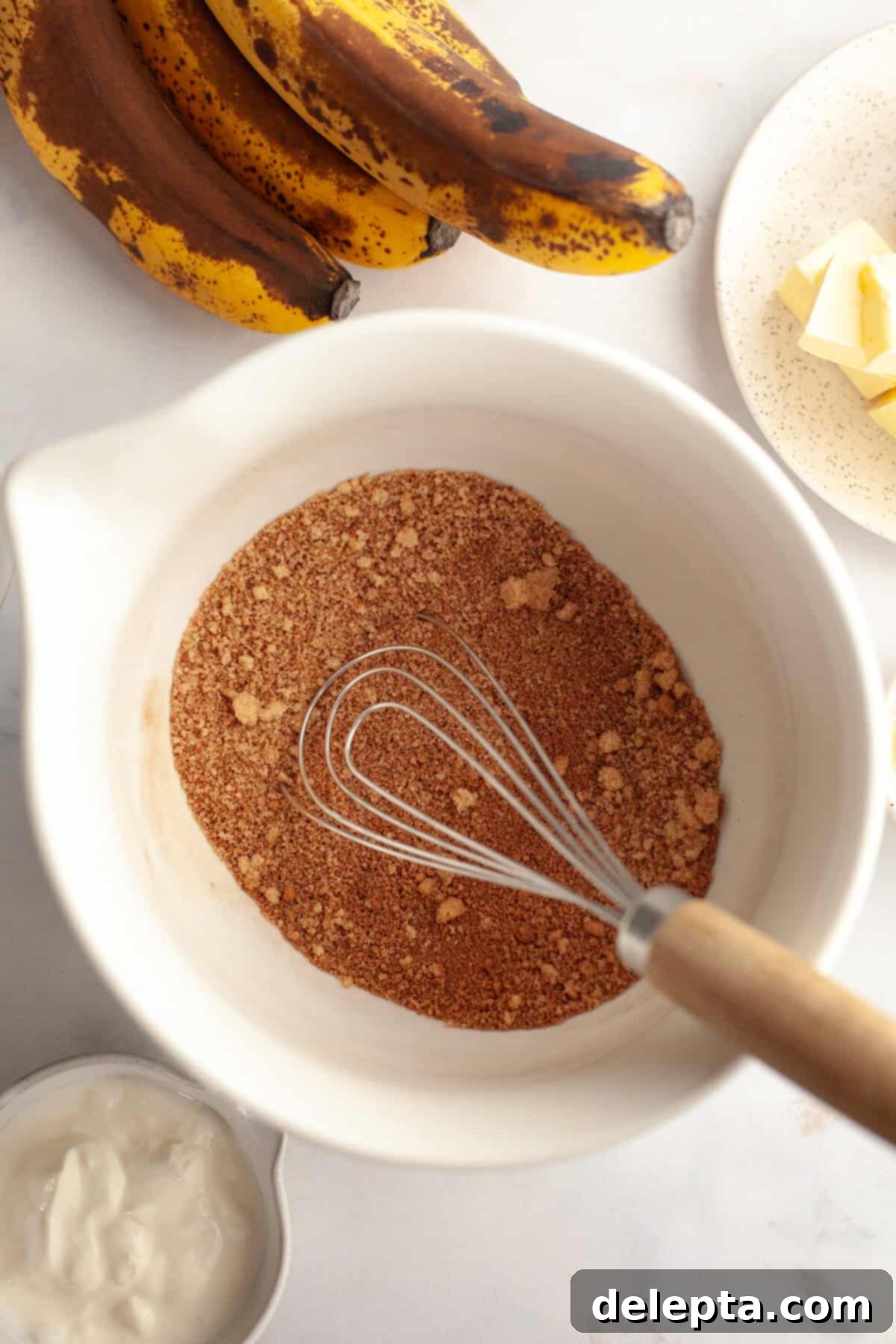 Perfectly Moist Banana Coffee Cake with Tangy Sour Cream 4 A large white bowl containing brown sugar and cinnamon, prepared for the filling.