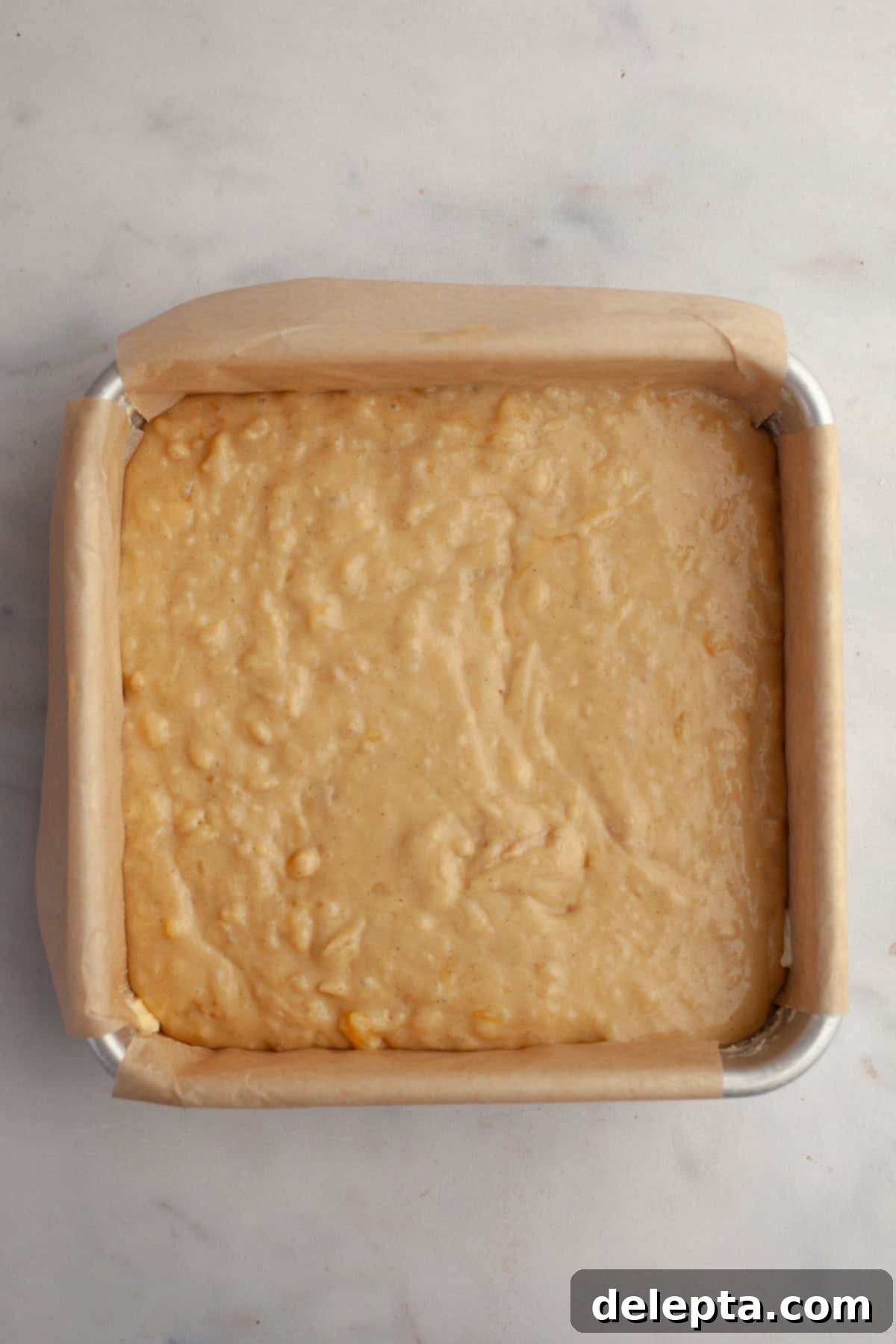 Banana Peanut Butter Bliss 7 Unbaked banana cake batter poured into a square baking pan, ready for the oven.
