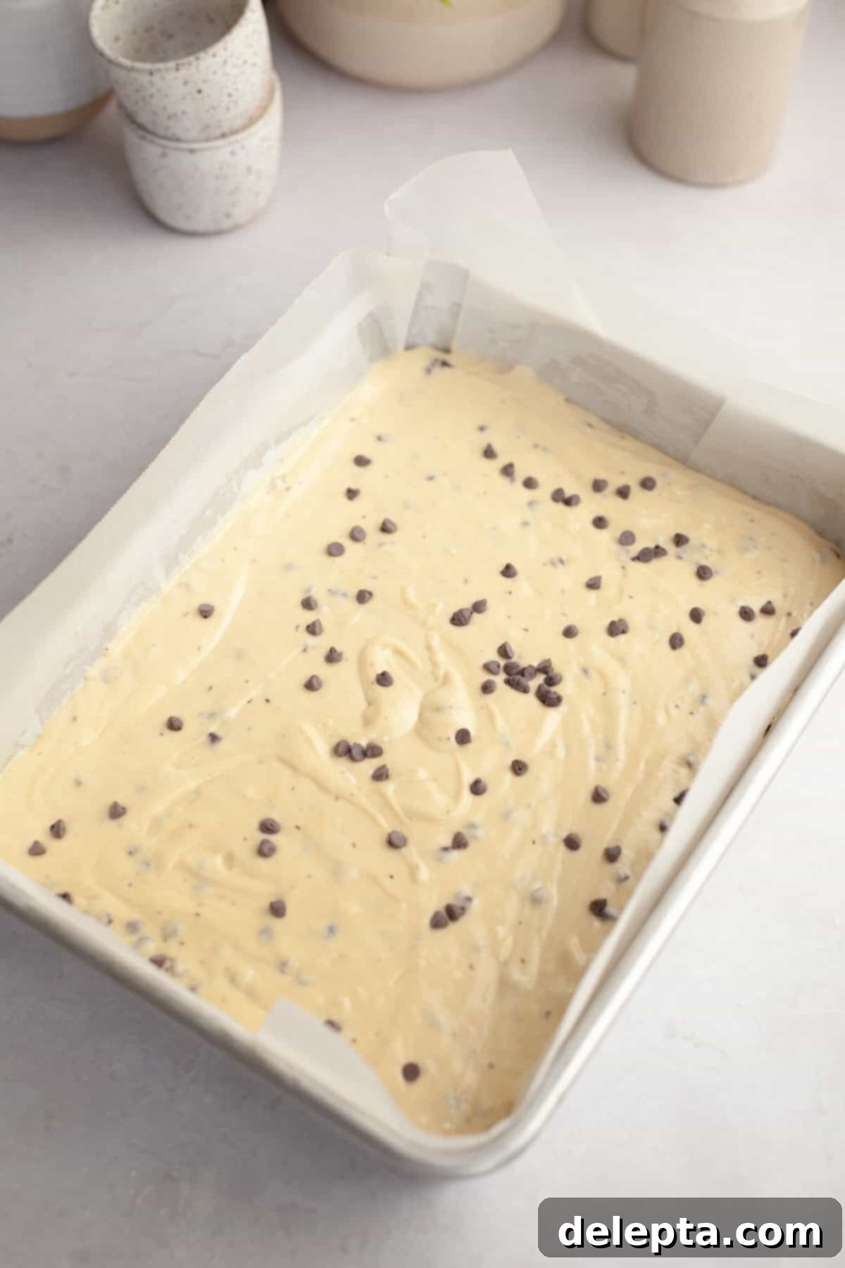 Double Chocolate Chip Sheet Cake 7 Unbaked chocolate chip sheet cake in a large 9x13-inch baking pan.