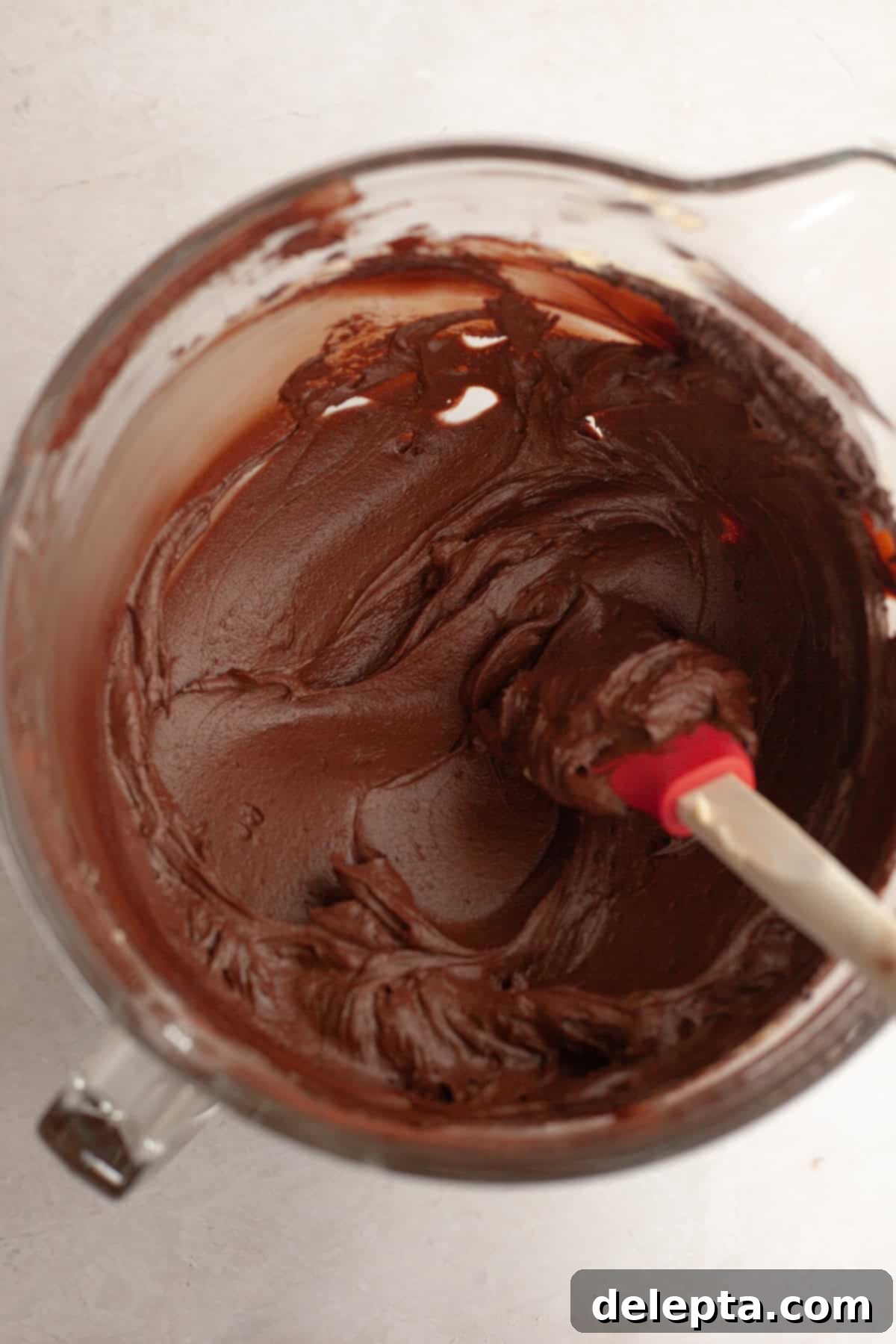 Double Chocolate Chip Sheet Cake 8 Chocolate fudge frosting in a large glass bowl.