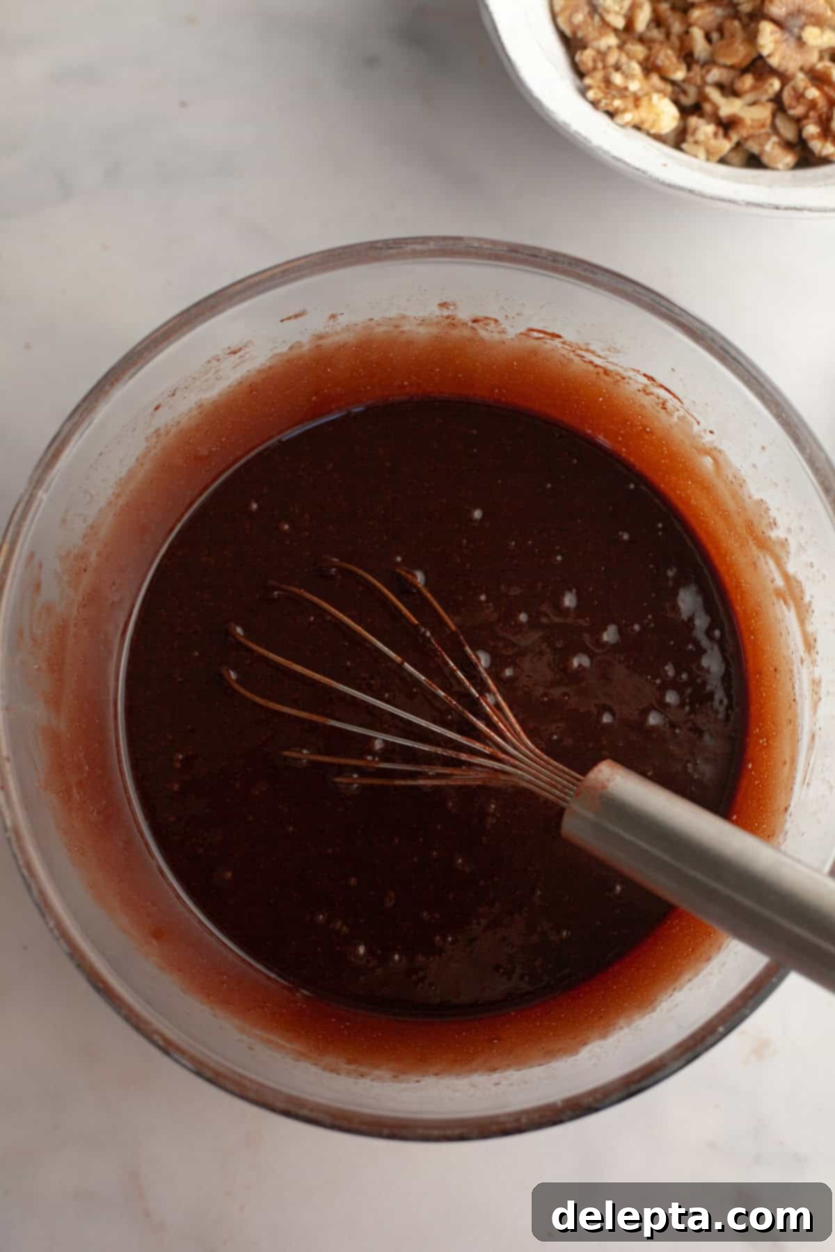 One Bowl Wonder Fudgy Walnut Brownies 5 Brownie batter in a glass bowl with a whisk.