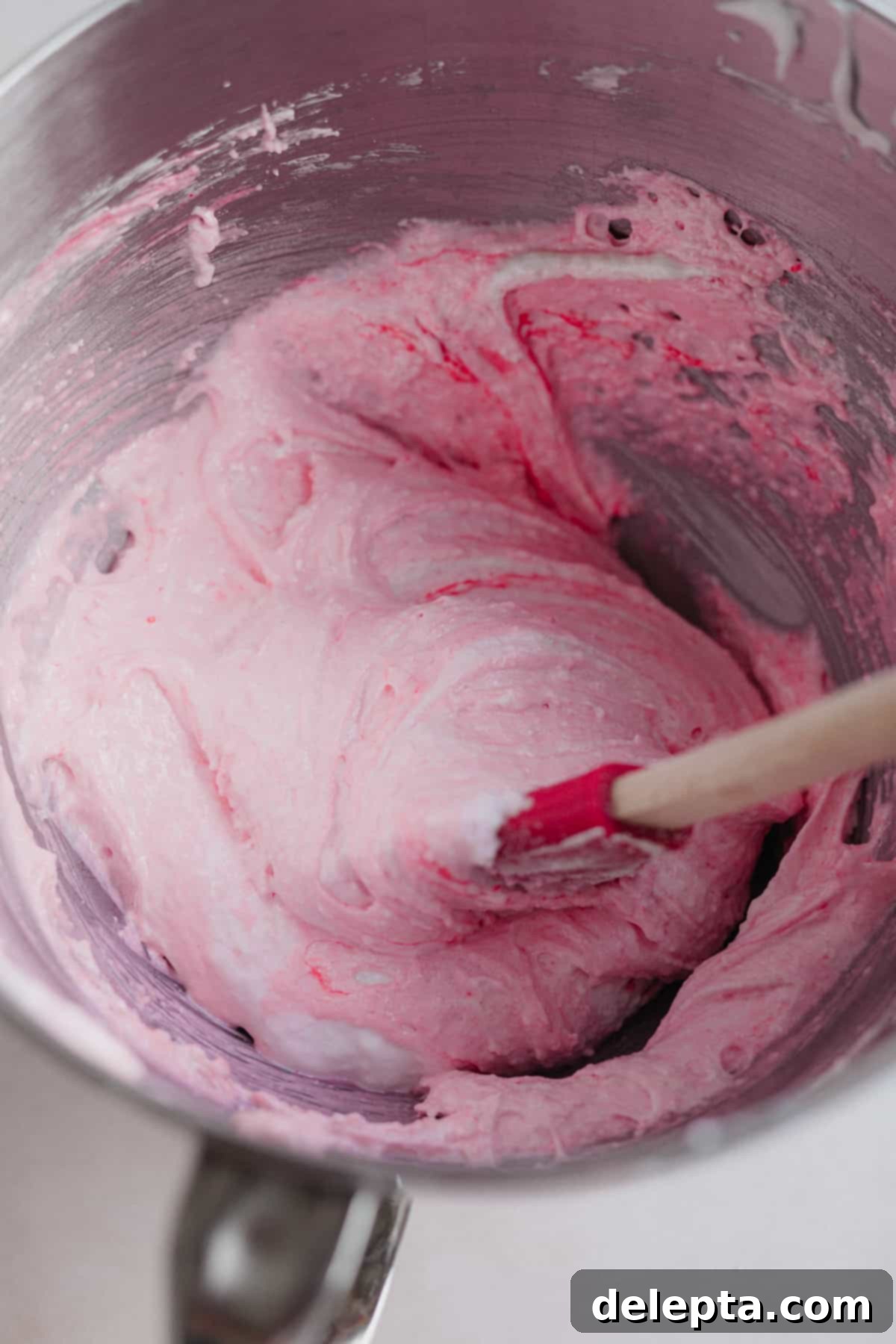Funfetti Macarons 8 A stand mixer bowl with pink macaron batter