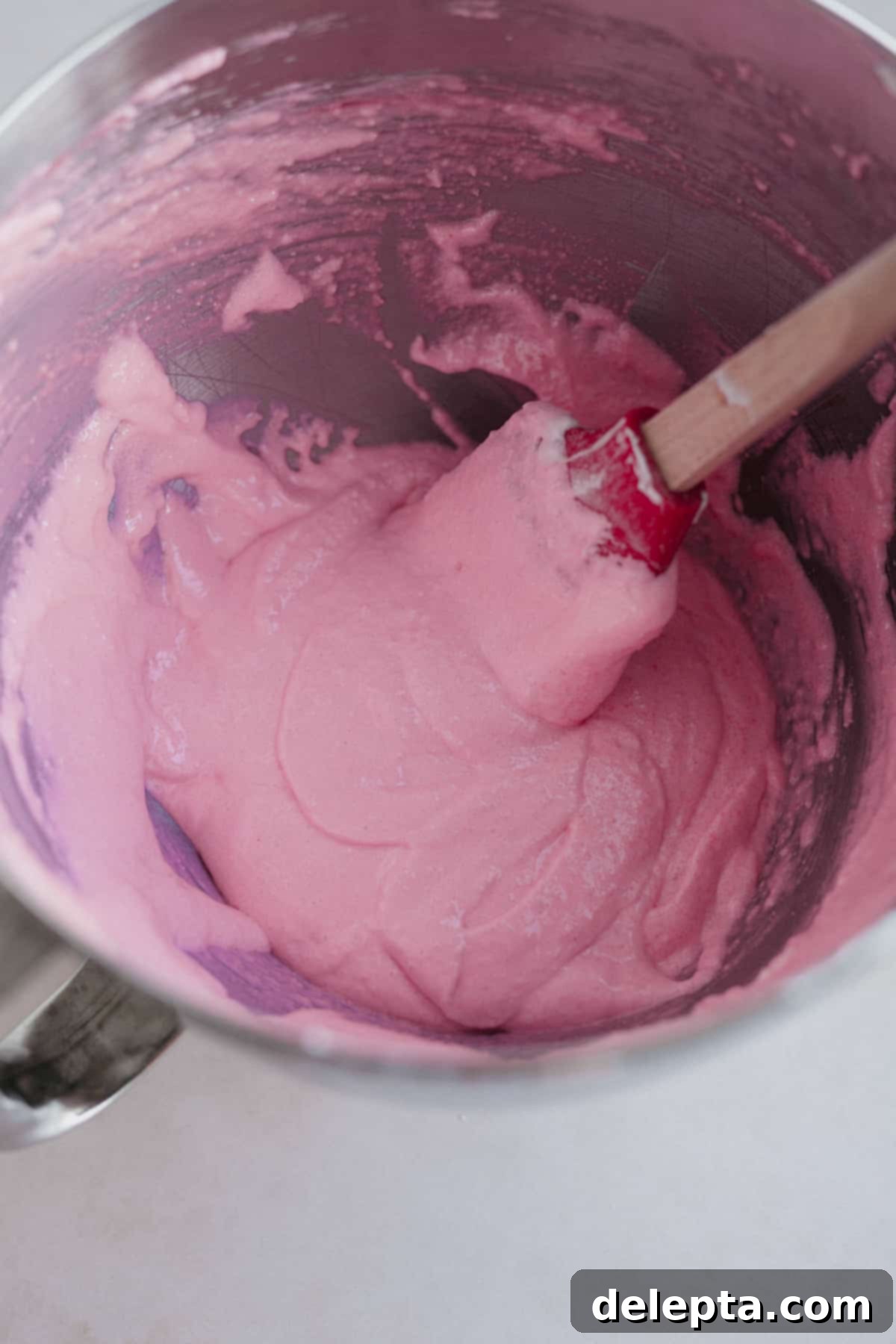 Funfetti Macarons 9 A stand mixer bowl with pink macaron batter
