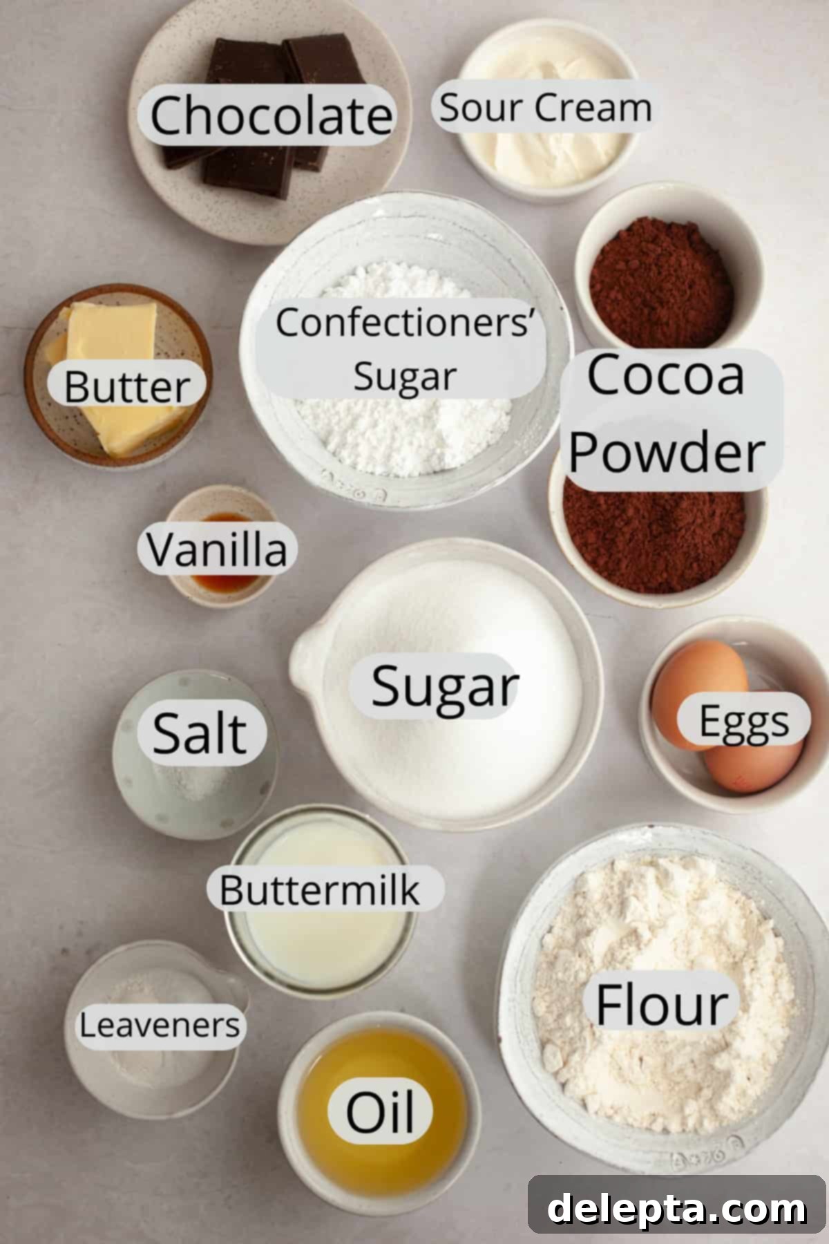 Easy Chocolate Sheet Cake 3 All the ingredients needed to make a single layer chocolate cake with chocolate sour cream frosting, weighed out into small bowls, ready for baking.