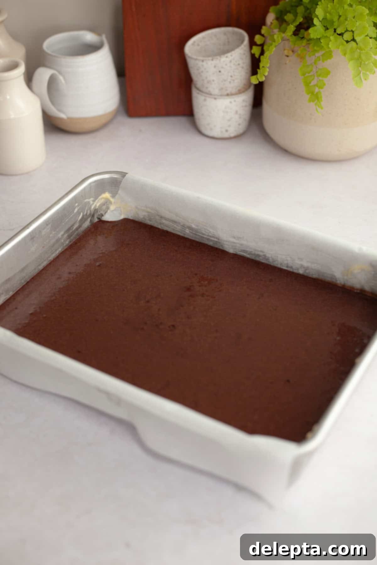 Easy Chocolate Sheet Cake 7 Unbaked chocolate cake batter in a rectangular pan, ready for the oven.