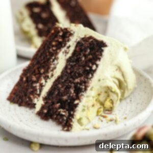 Decadent Chocolate Pistachio Dream Cake 12 A slice of pistachio chocolate cake on a small plate.