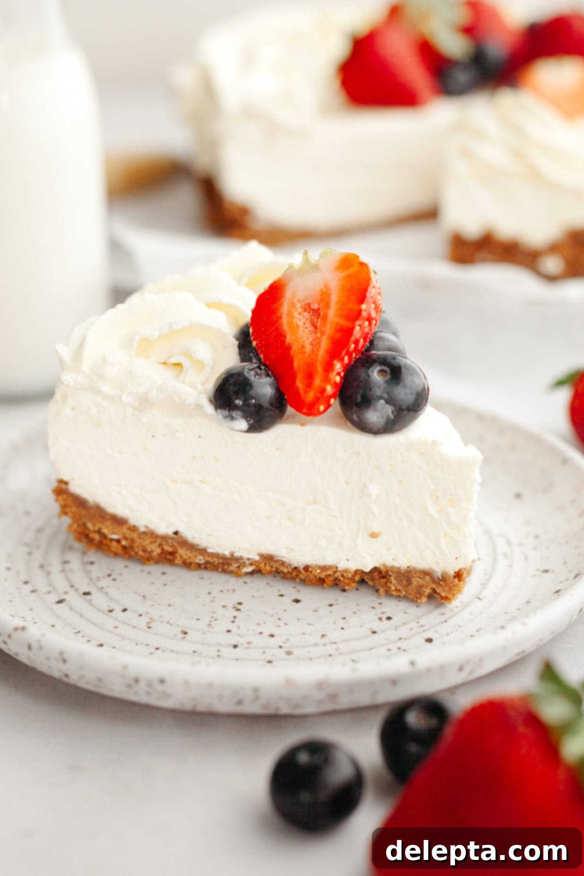 Gelatin-Free No-Bake Vanilla Cheesecake 2 A close up of a vanilla no bake cheesecake, decorated with fresh berries.