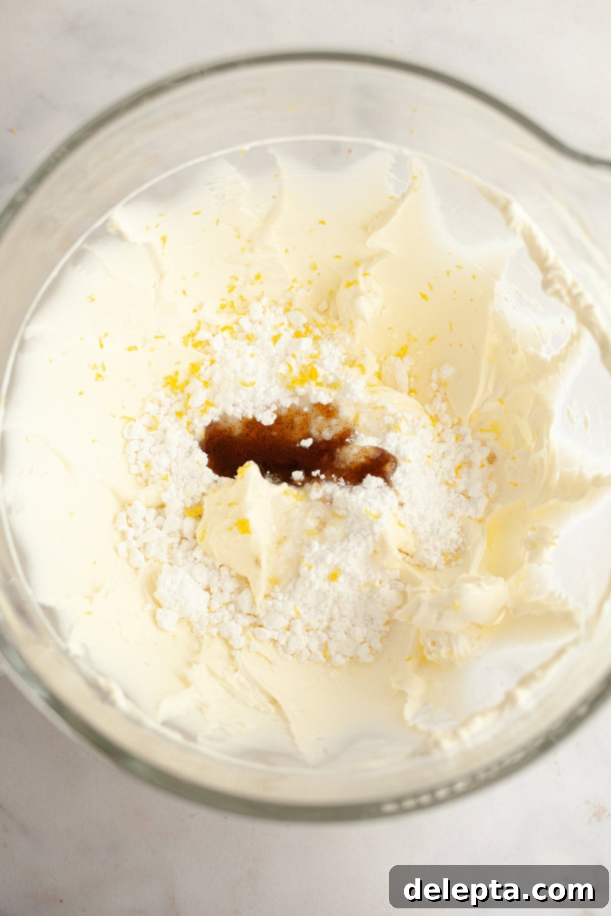 Gelatin-Free No-Bake Vanilla Cheesecake 5 A large mixing bowl with cream cheese, lemon zest, sugar, and vanilla.
