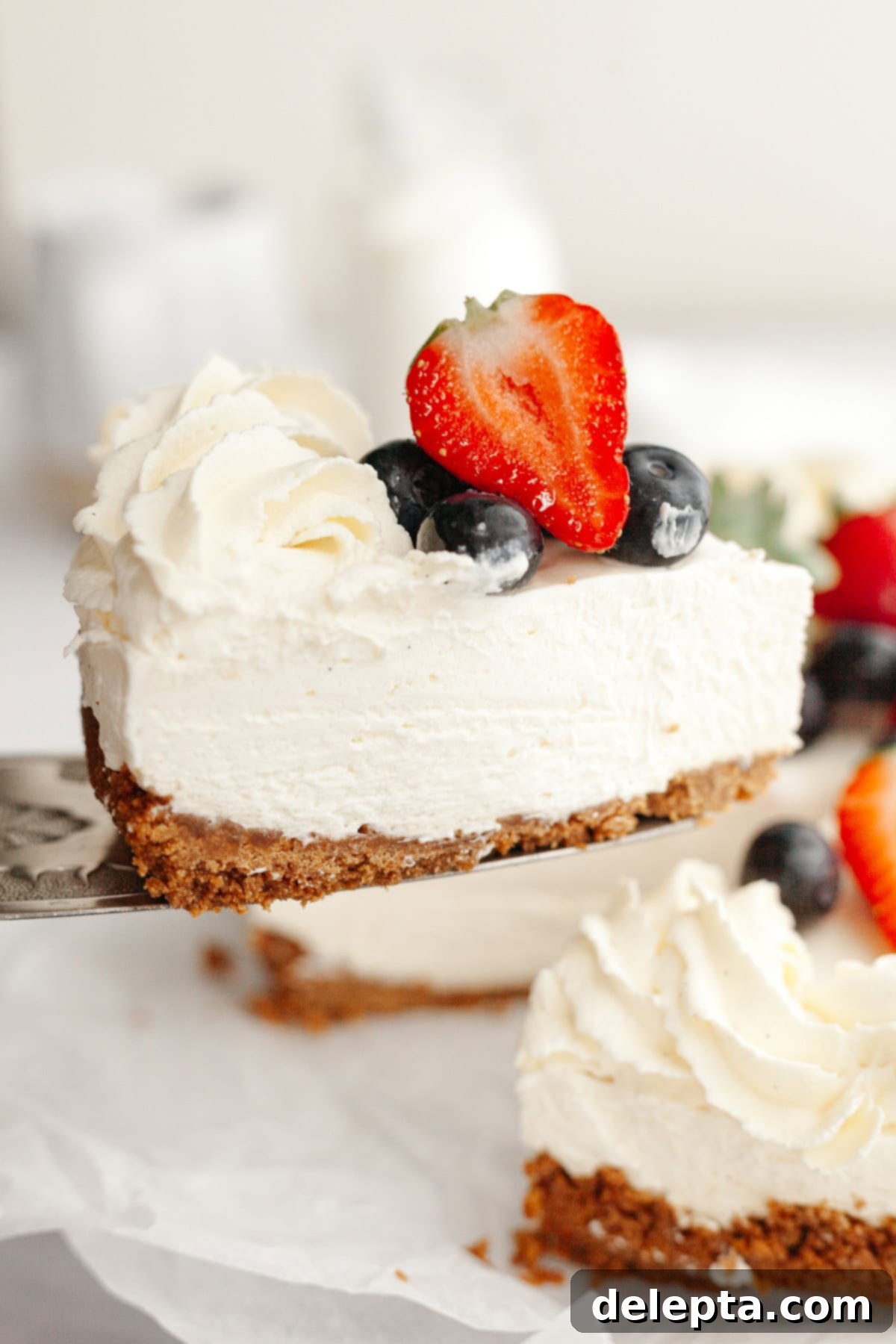 Gelatin-Free No-Bake Vanilla Cheesecake 10 A close up of a vanilla no bake cheesecake, decorated with fresh berries.