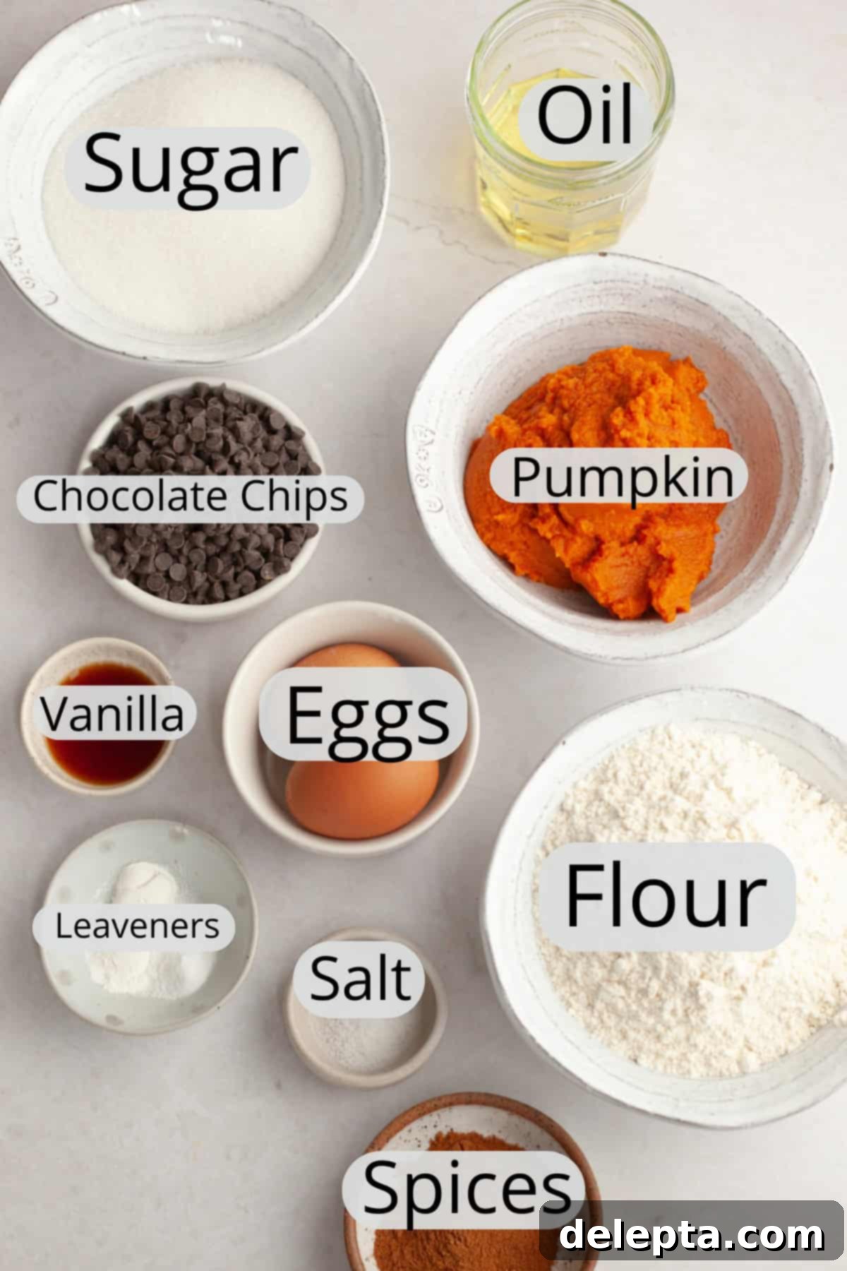 Easy One-Bowl Chocolate Chip Pumpkin Cake 3 All the ingredients needed to make a chocolate chip pumpkin cake, weighed out into small bowls, emphasizing the simplicity of the recipe.