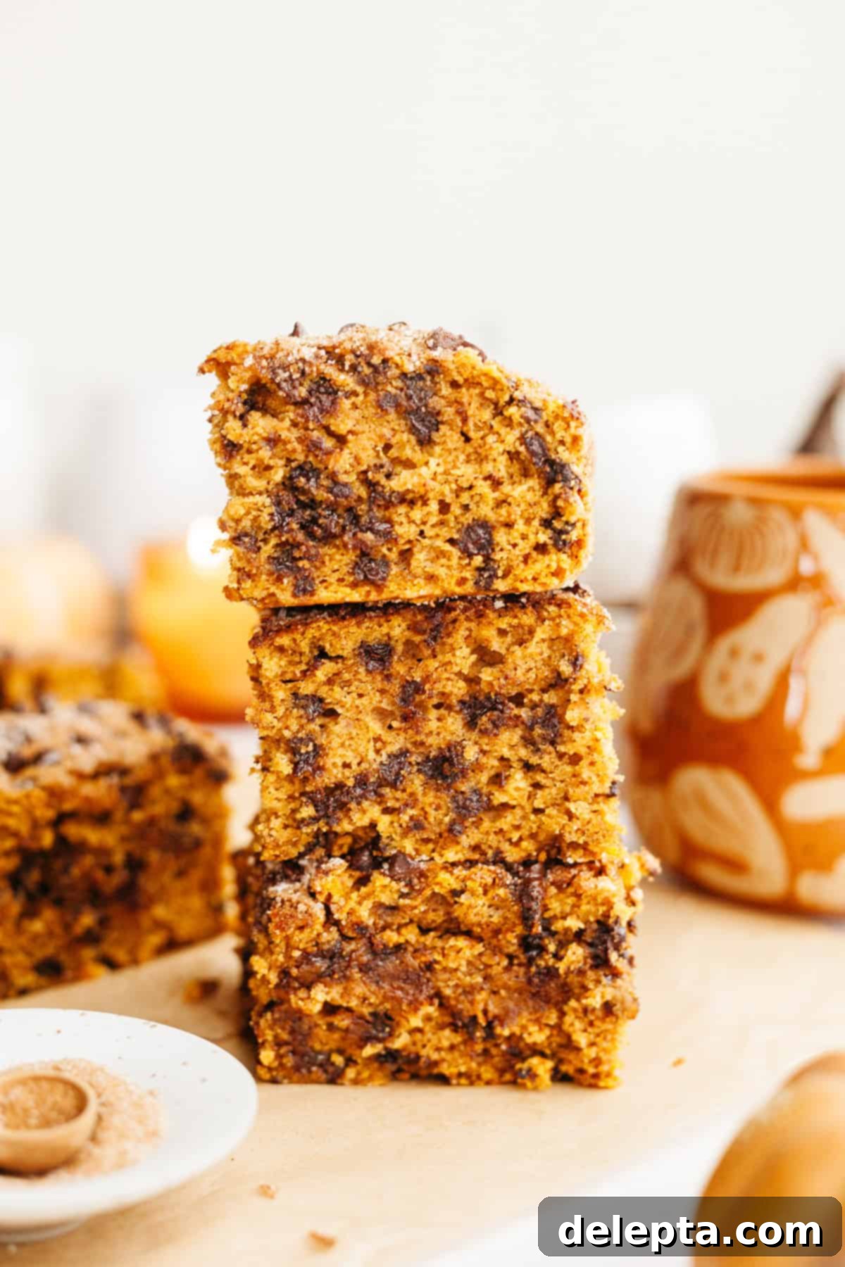 Easy One-Bowl Chocolate Chip Pumpkin Cake 9 A stack of three slices of pumpkin chocolate chip cake, revealing its moist crumb and even distribution of chocolate chips.