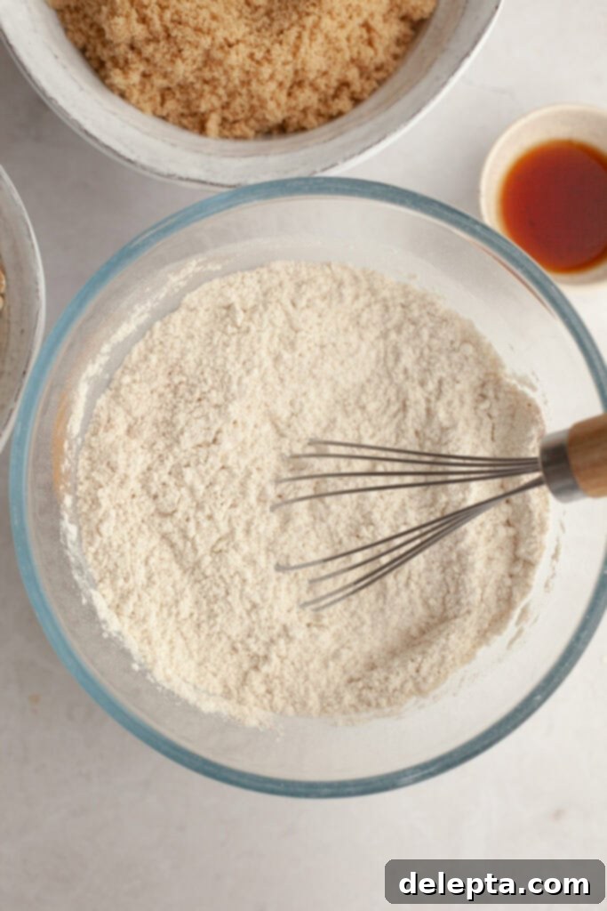 Aromatic Cardamom Oatmeal Cookies with Maple Espresso Glaze 5 All-purpose flour in a small glass bowl, ready to be whisked with dry ingredients.