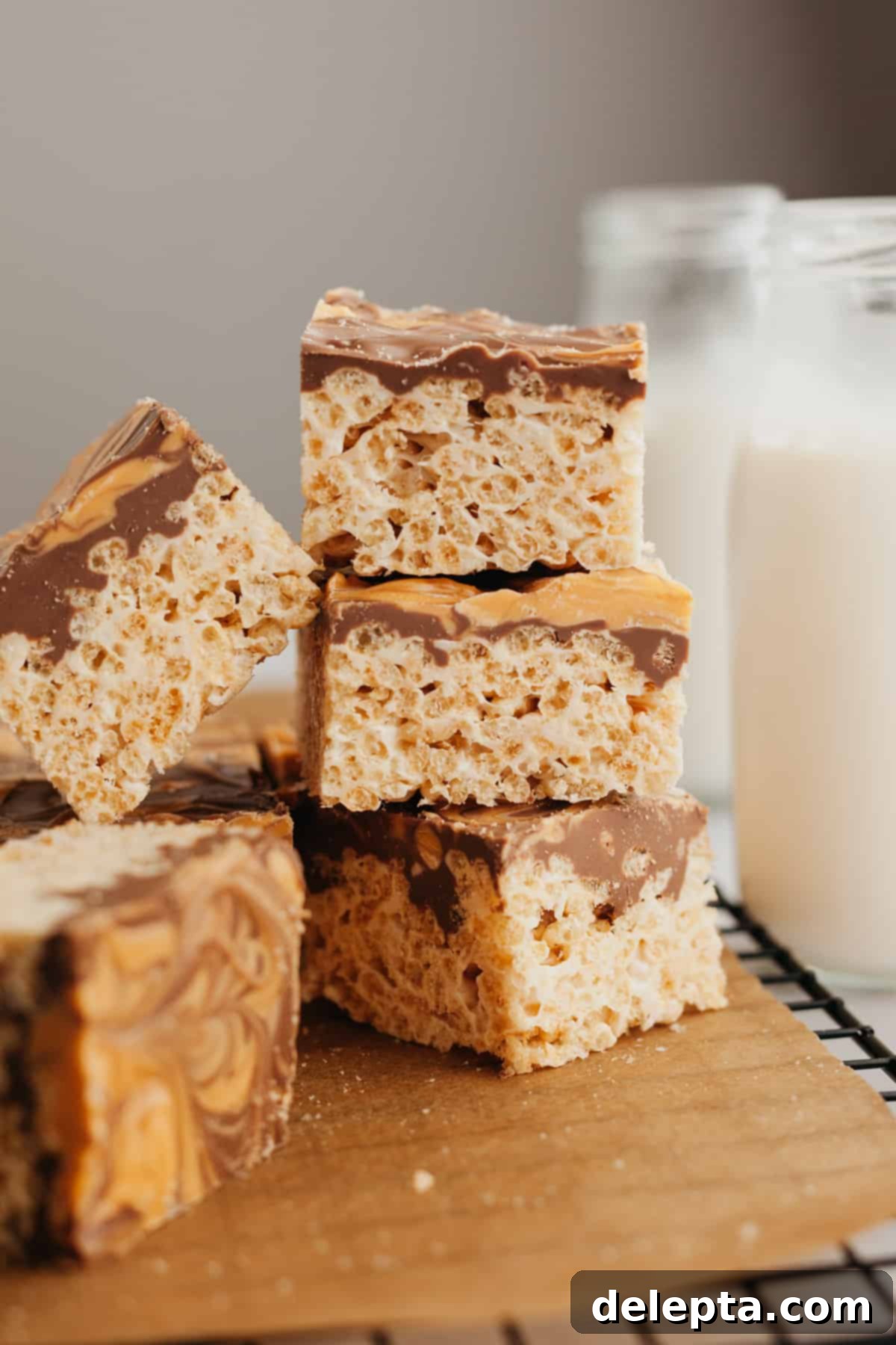 Sweet Chocolate Crispy Delights 2 A small stack of rich chocolate-covered Rice Krispie treats, beautifully swirled with golden butterscotch and sprinkled with flaky sea salt.