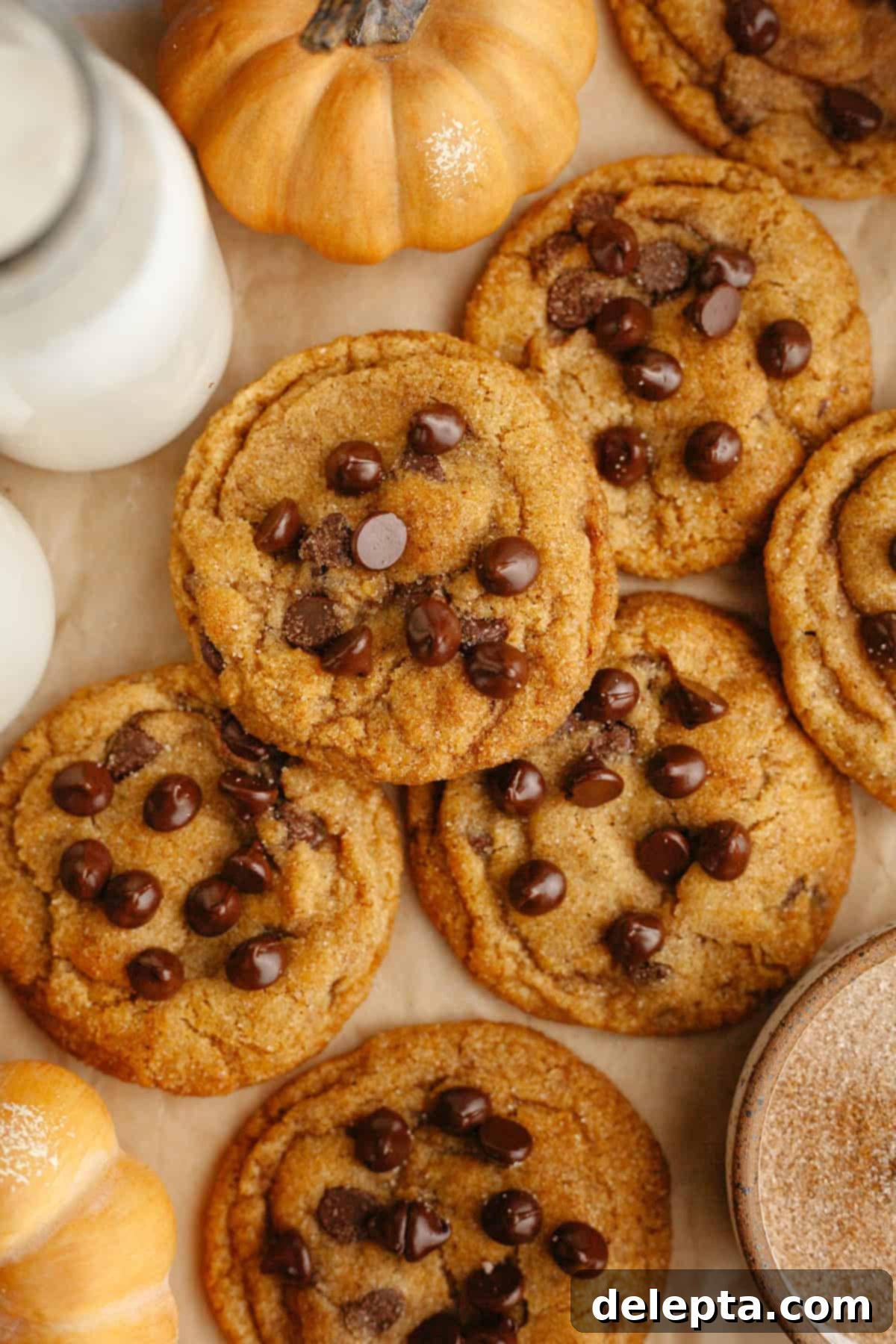 Nutty Brown Butter Pumpkin Chocolate Chip Cookies 2 Brown butter pumpkin chocolate chip cookies on brown parchment paper.