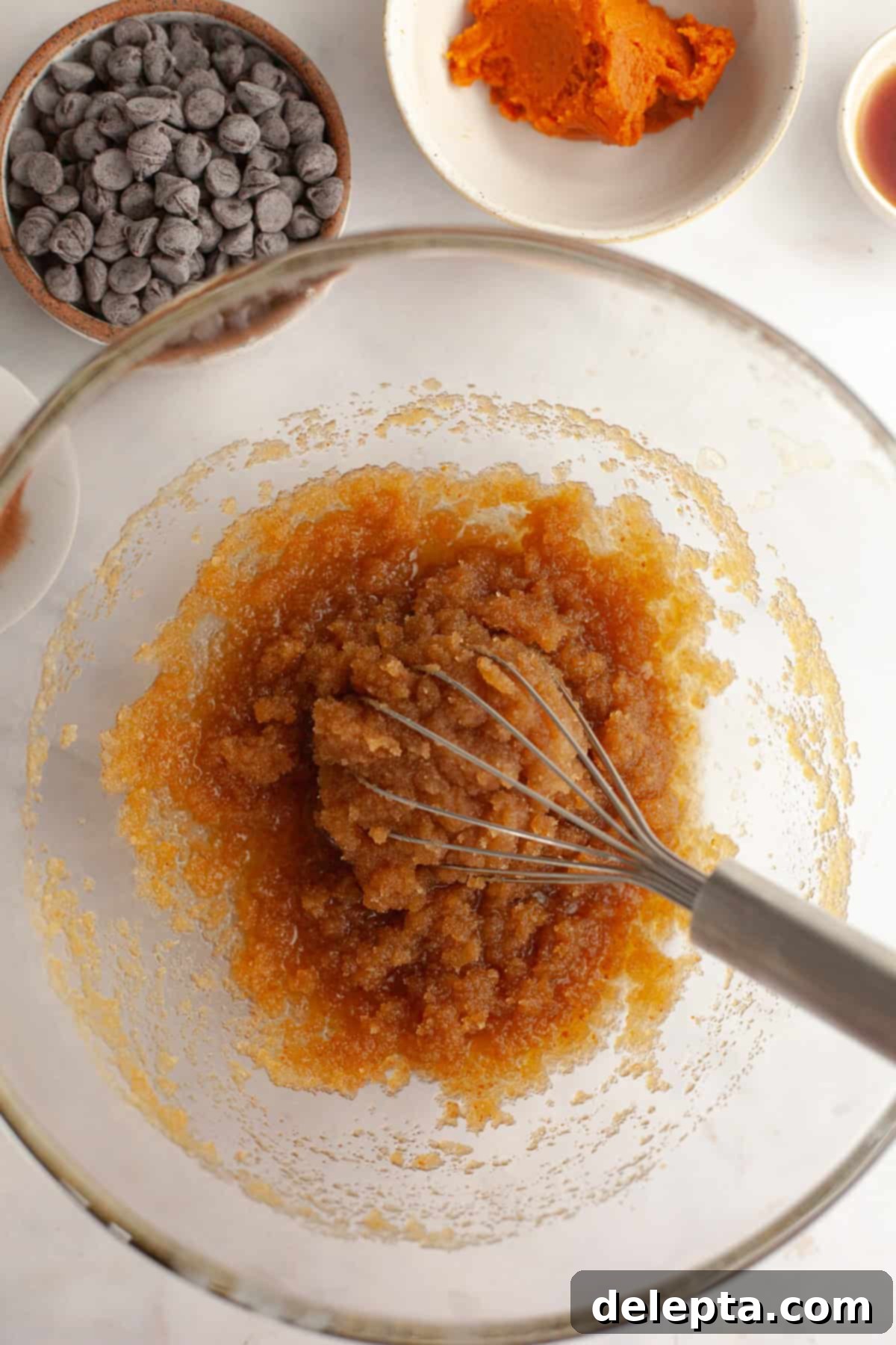 Nutty Brown Butter Pumpkin Chocolate Chip Cookies 5 Melted butter and sugar in a glass bowl with a whisk.