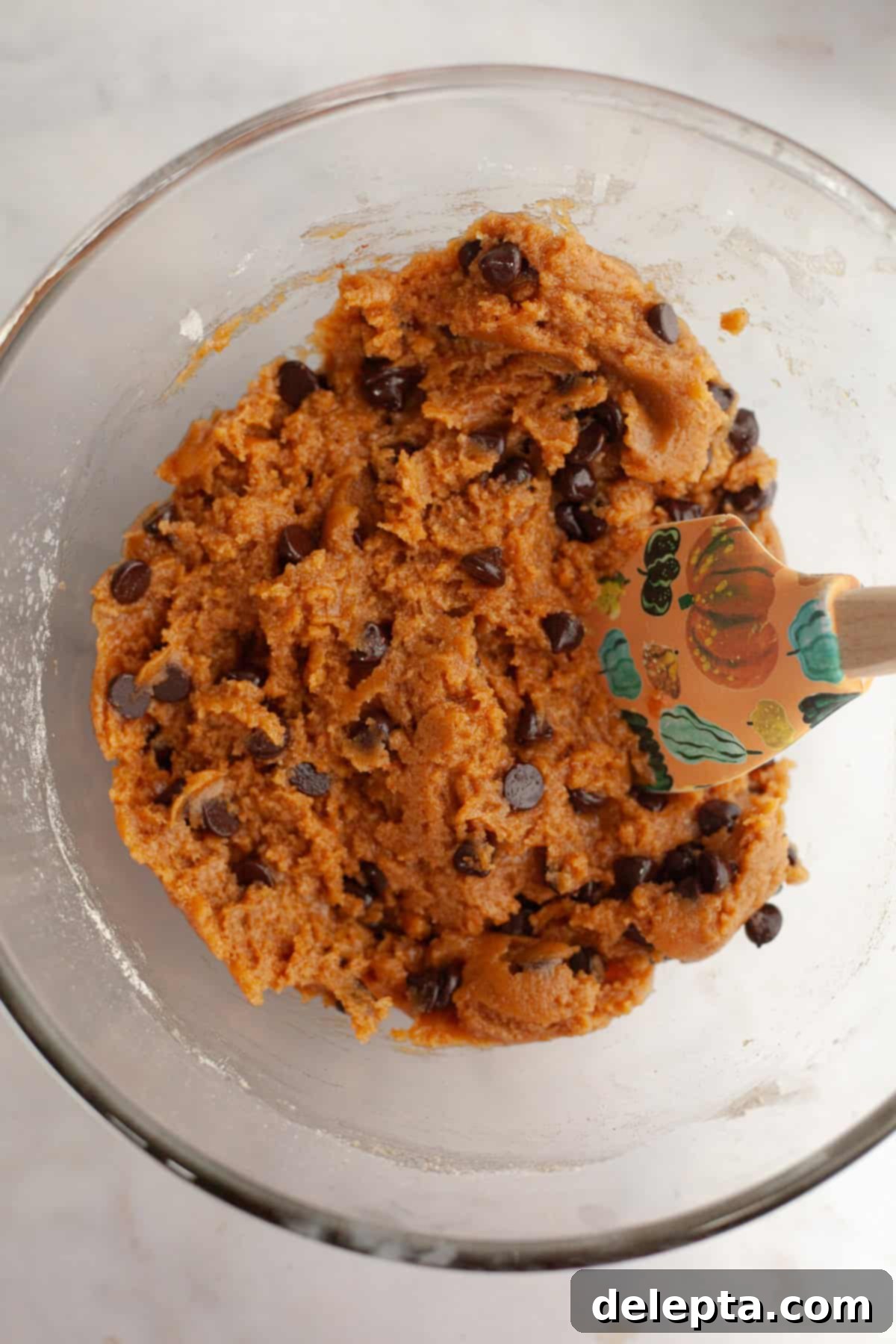 Nutty Brown Butter Pumpkin Chocolate Chip Cookies 7 Pumpkin chocolate chip cookie dough in a glass bowl.