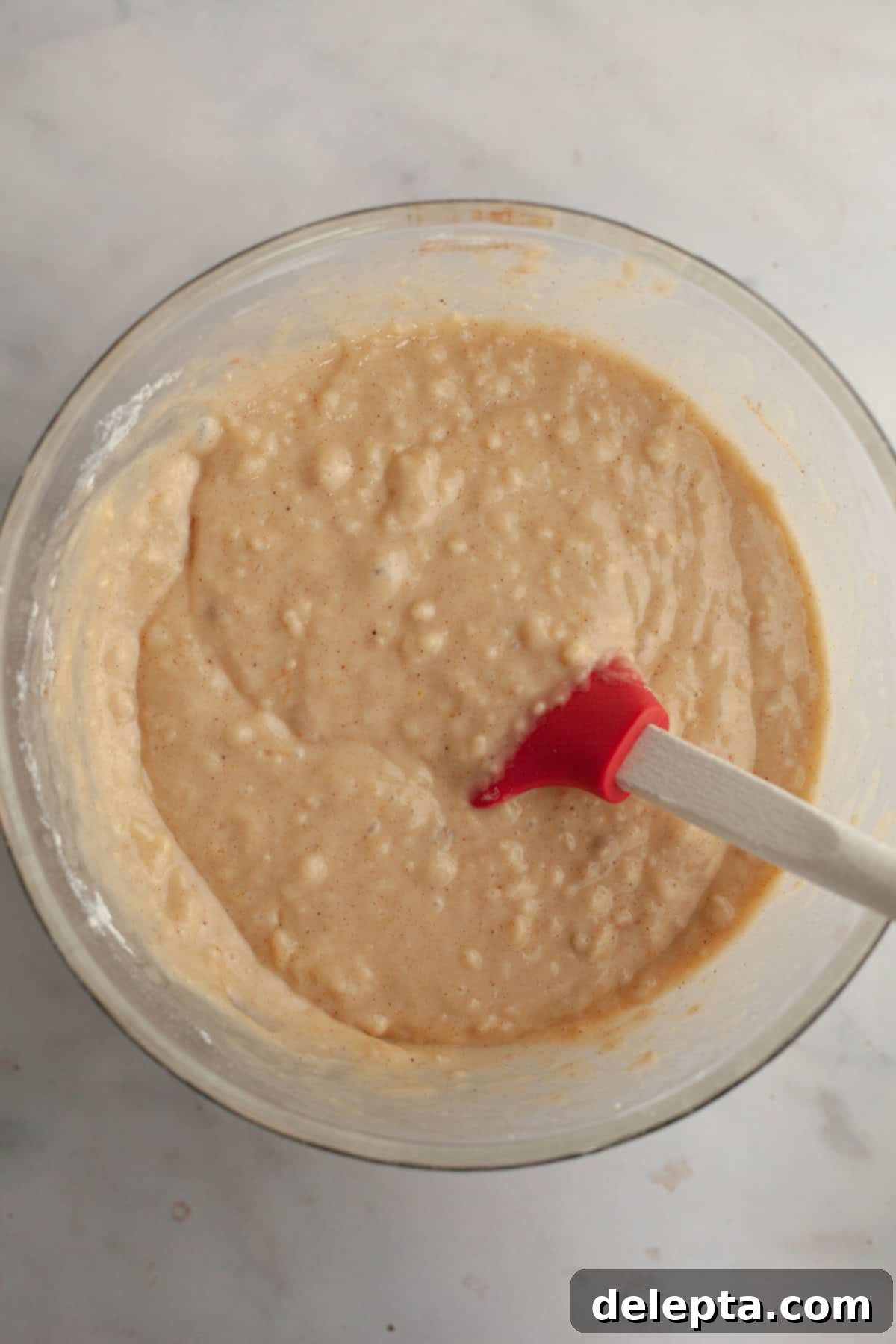 Bite-Sized Cinnamon Bliss 5 Cinnamon muffin batter in a glass bowl.