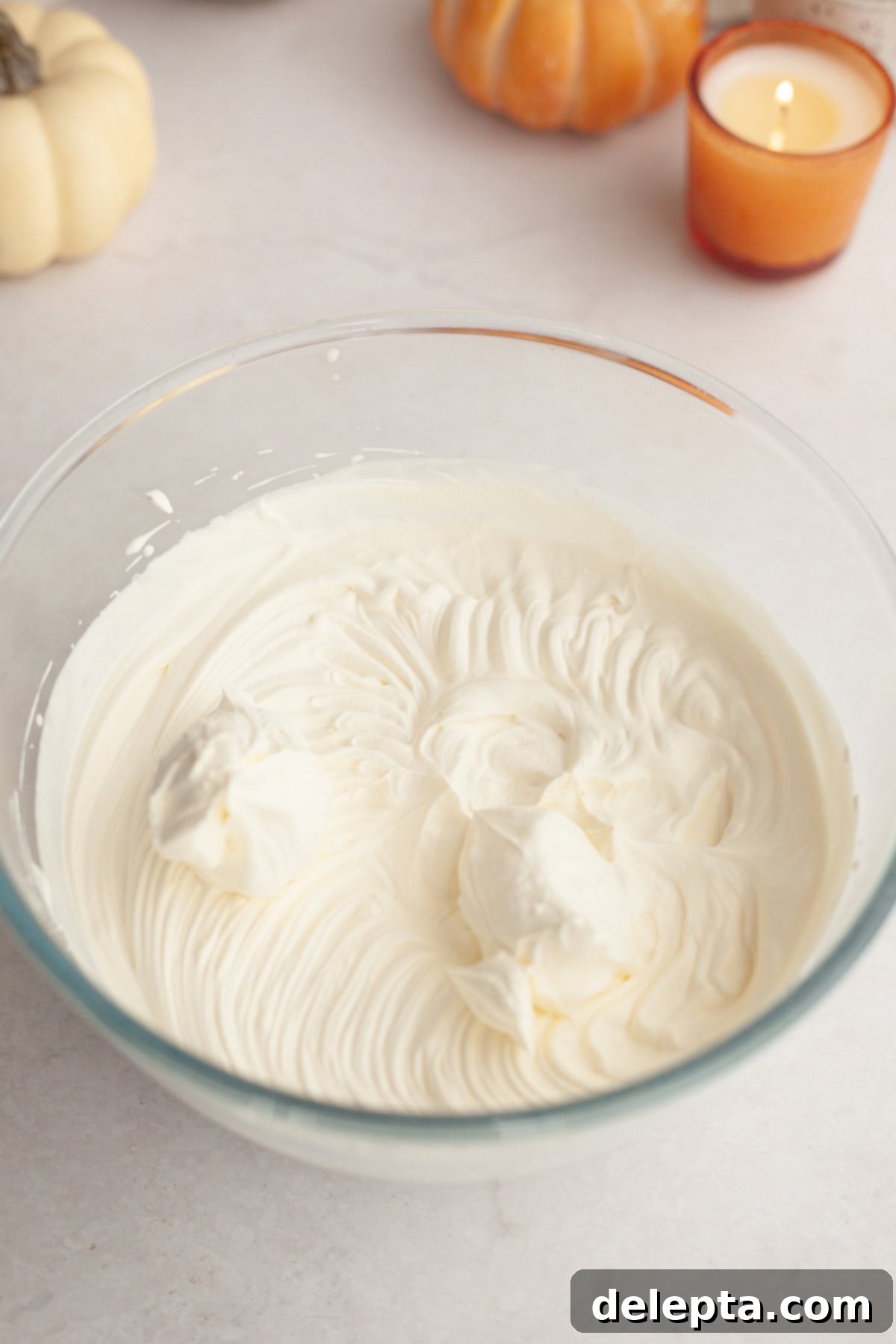 Spiced No-Bake Pumpkin Cheesecake Bars 6 Fluffy whipped cream in a glass bowl, perfectly stiff for the cheesecake filling.
