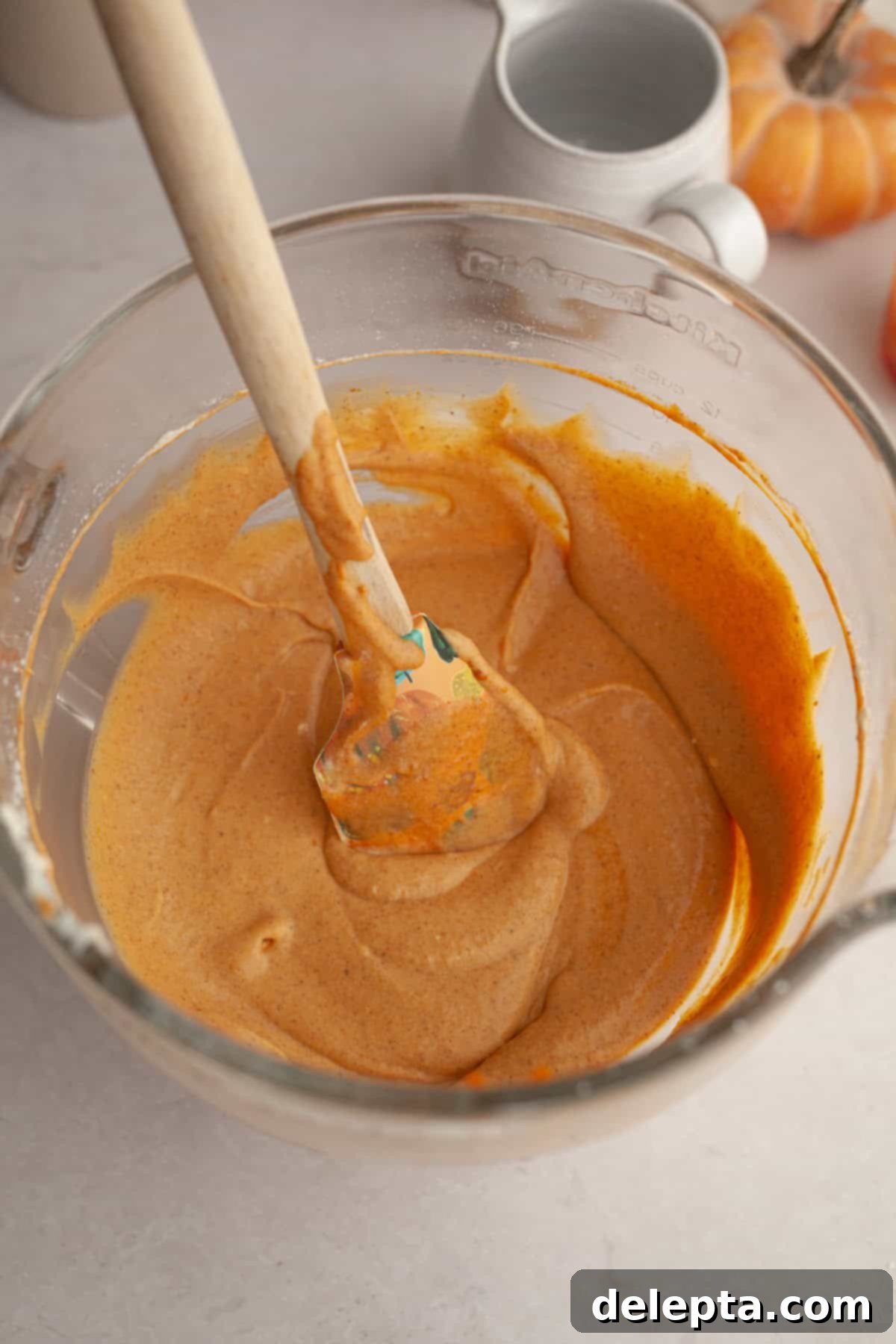 Spiced No-Bake Pumpkin Cheesecake Bars 7 Pumpkin cheesecake filling in a large bowl, smooth and creamy, ready for the next step.