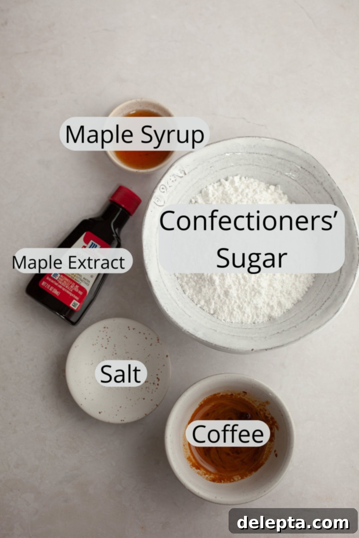 Maple Espresso Glaze 3 All the ingredients needed to make a maple espresso glaze, precisely weighed out into small bowls, including maple syrup, coffee, and confectioners' sugar.